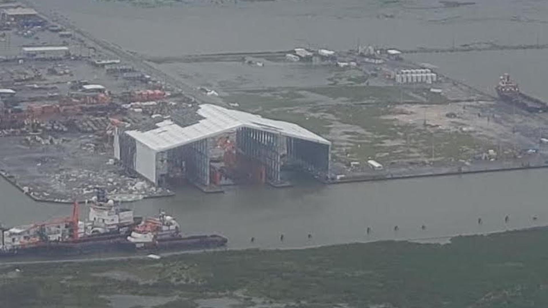 Aerial view of a damaged building and boat.