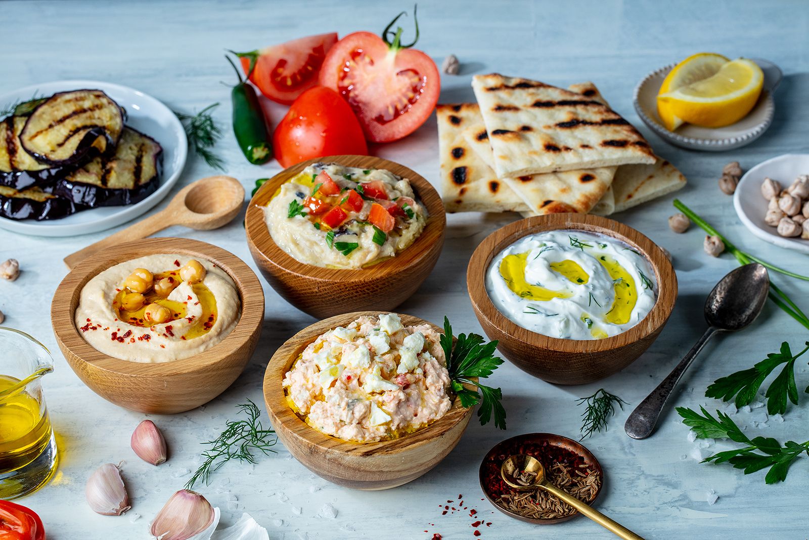 a bunch of fresh greek dips 
