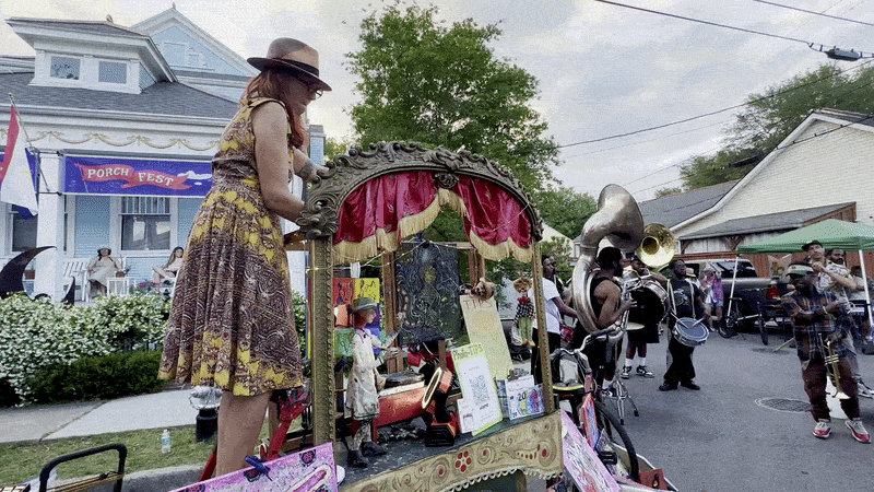 Image shows a puppeteer and band on the streets of New Orleans.