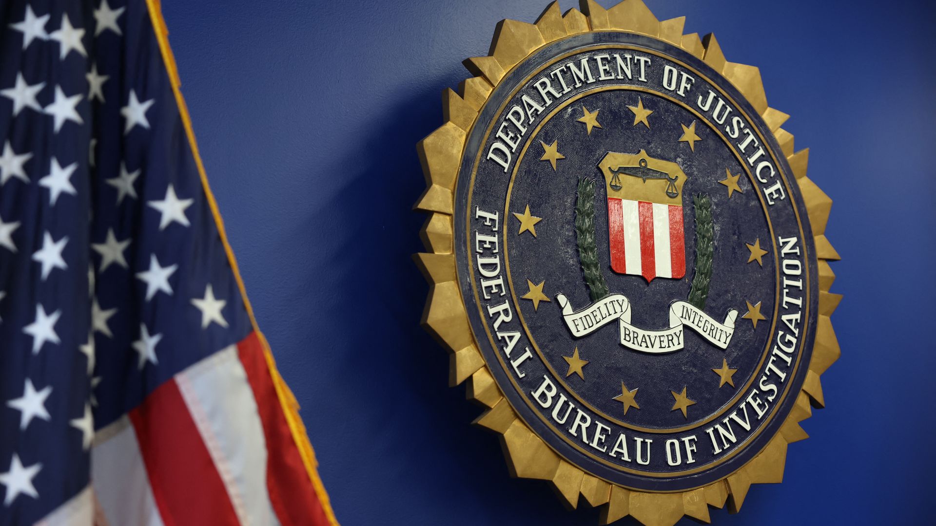 An image of the logo for the Federal Bureau of Investigation on a wall.