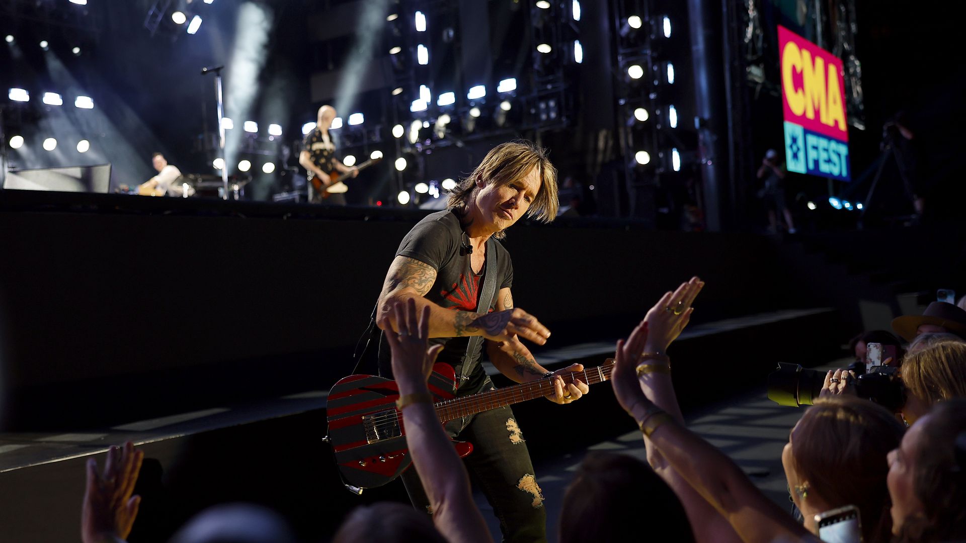 Keith Urban playing guitar during CMA Fest 2022 at Nissan Stadium.