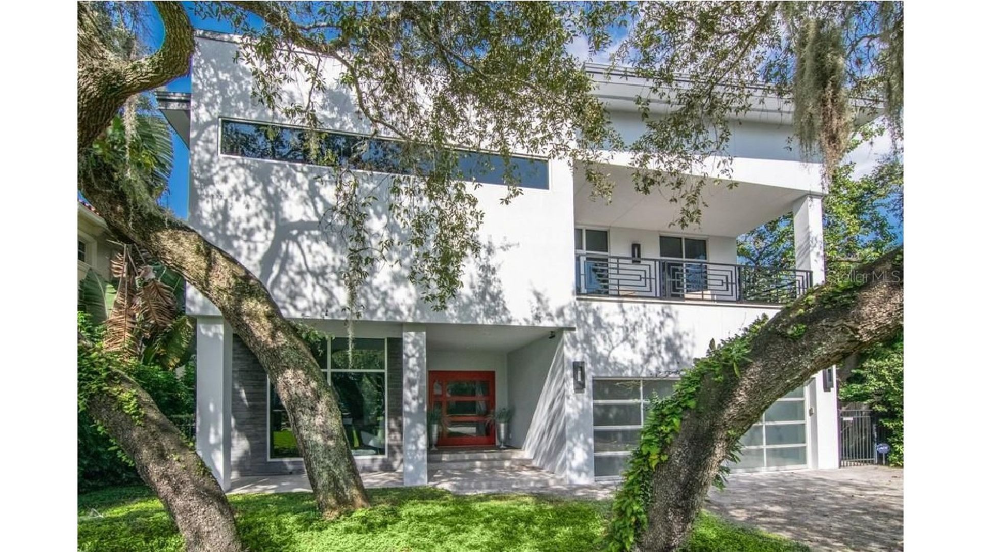 An exterior real estate shot of a two-story modern home in Tampa, Florida.