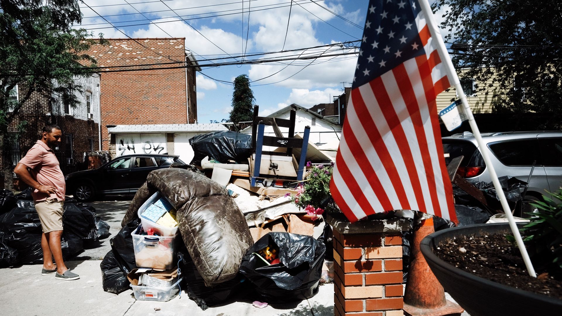  person sorts through belongings from their flooded home in a Queens neighborhood 