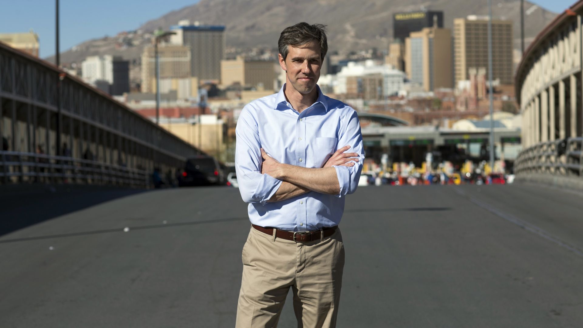 Texas Senate candidate Beto O'Rouke stands for a photo between the Mexico-Texas border