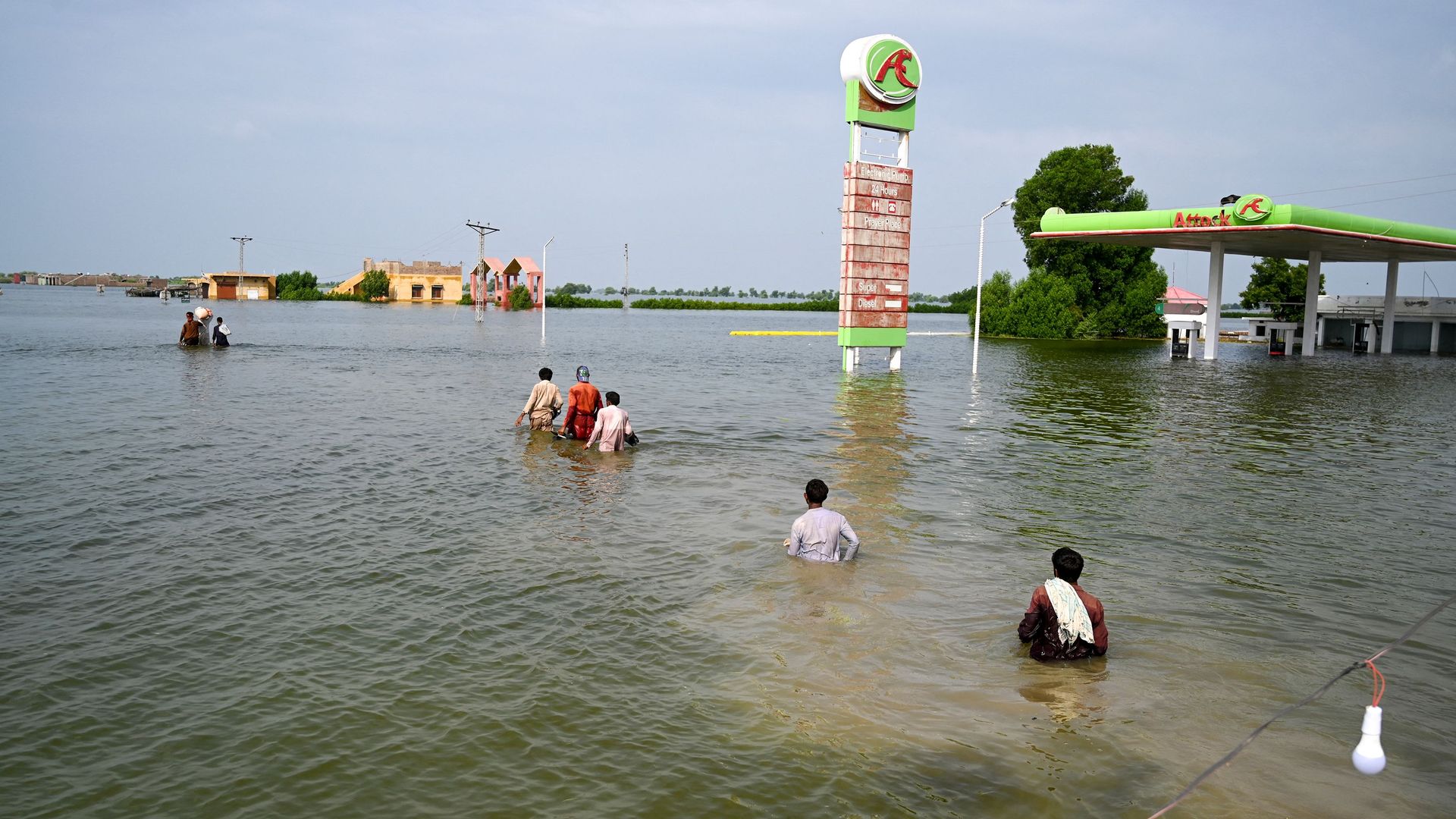 People walk in floodwaters after devastating monsoon rains in Pakistan in Sept. 2022.