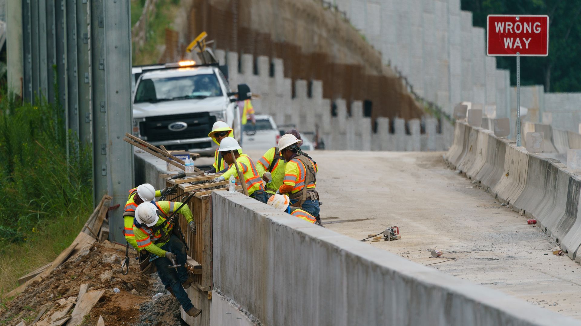 Construction workers are seen rebuilding a bridge in Georgia.