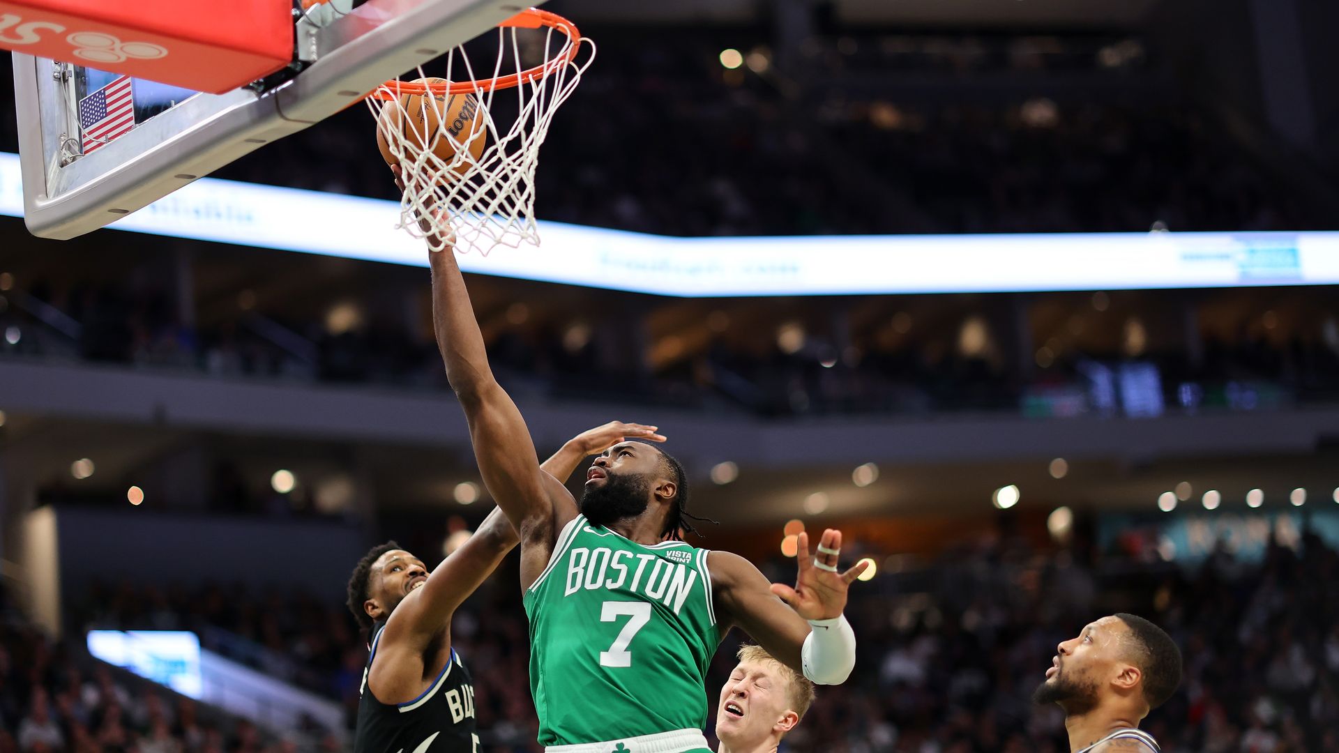 Jaylen Brown #7 of the Boston Celtics drives to the basket against Malik Beasley #5 of the Milwaukee Bucks during a game at Fiserv Forum on April 09, 2024 in Milwaukee, Wisconsin. 