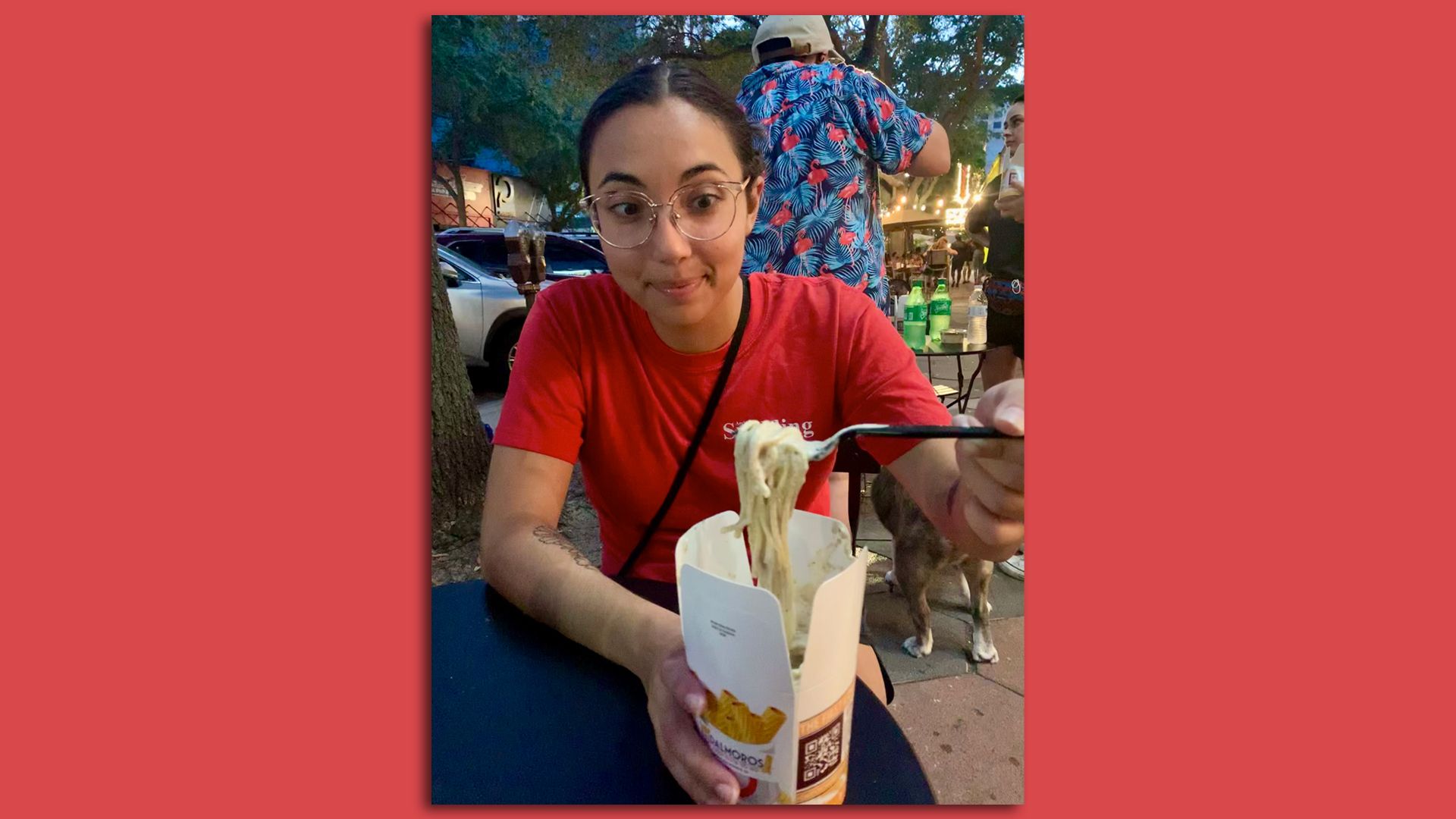 A picture of Selene staring eagerly at noodles twirled on her fork