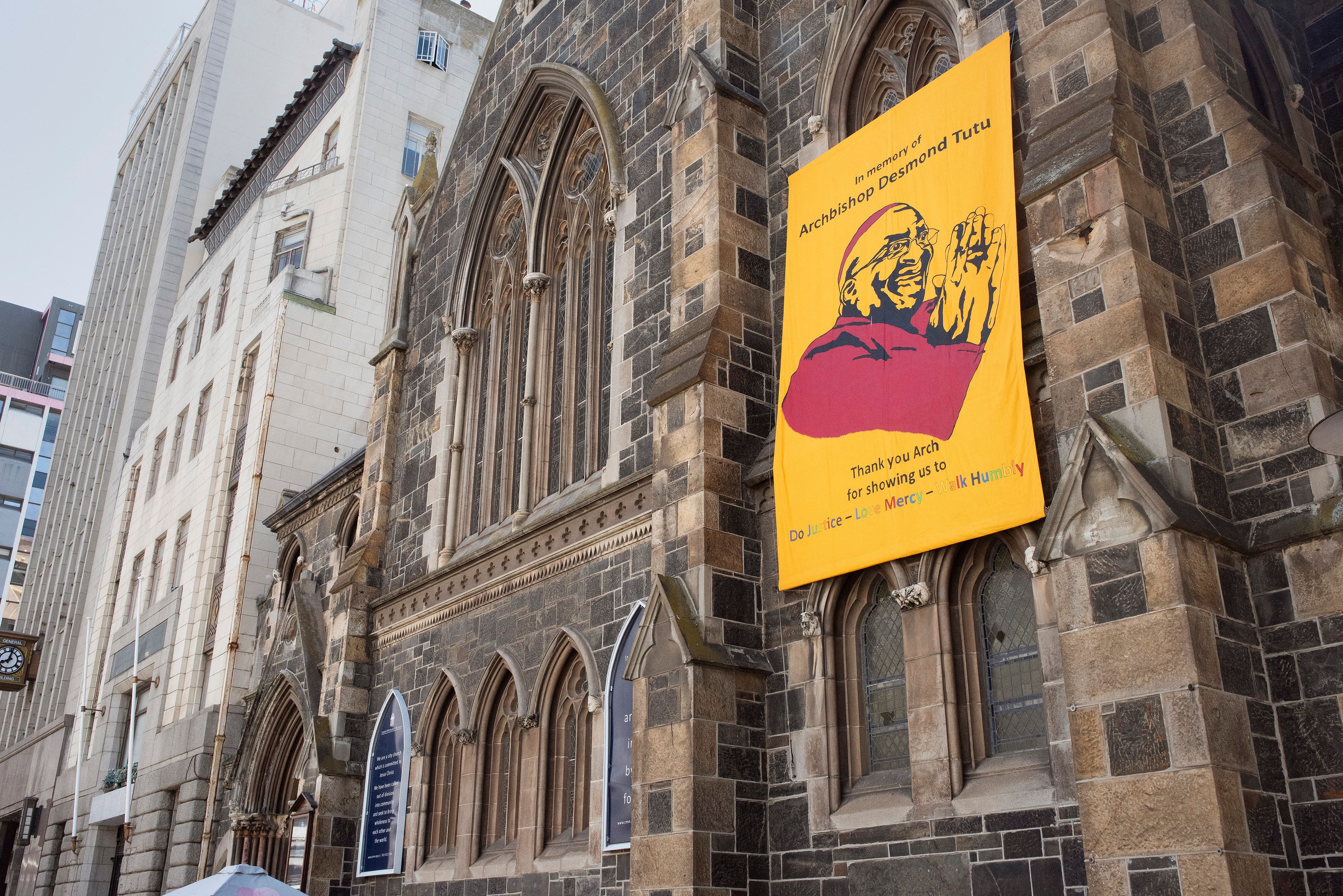 A poster of South African anti-apartheid icon Archbishop Desmond Tutu hangs at the Methodist Church after the news of his death, in Cape Town on December 26, 2021.