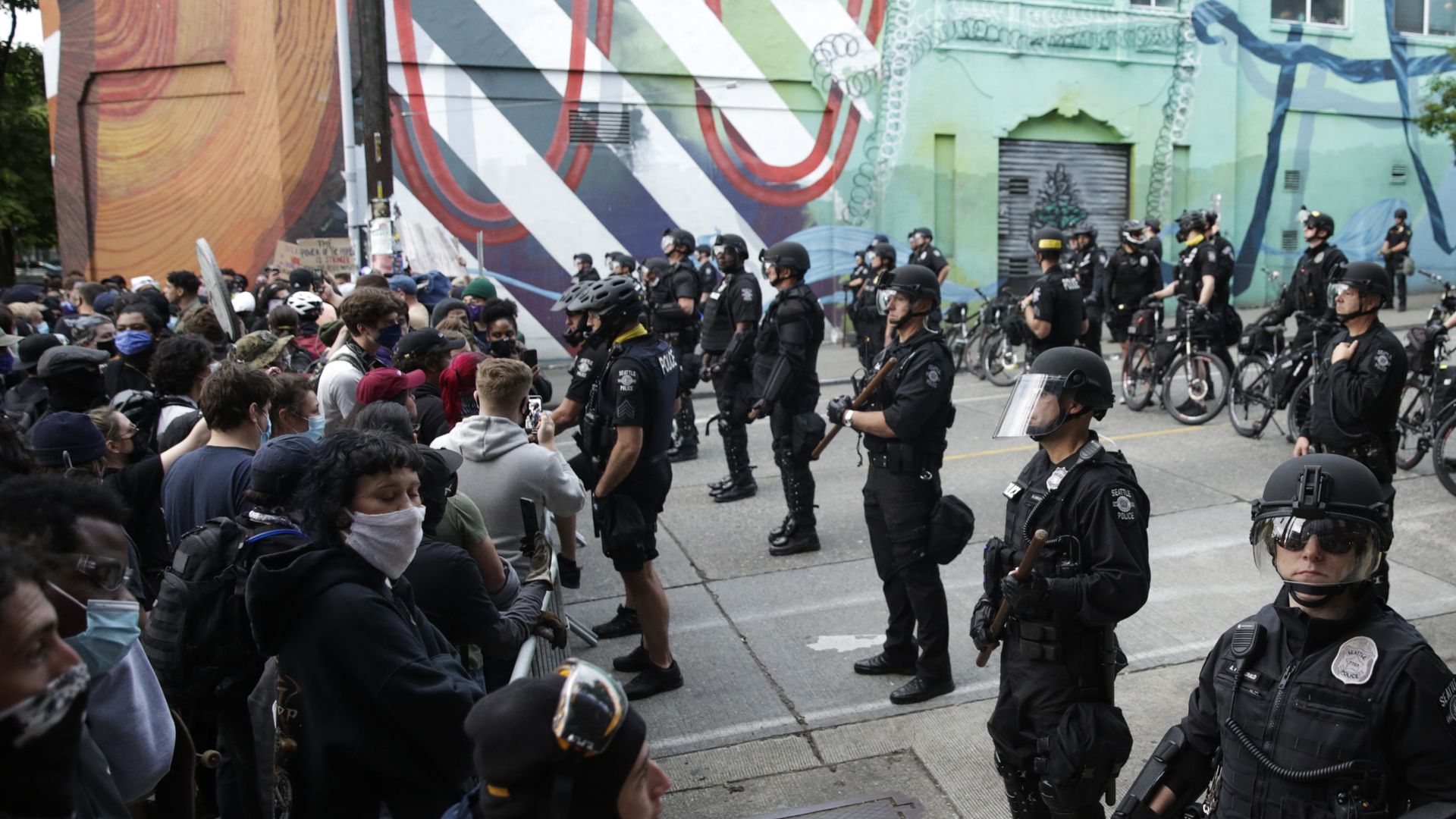 Seattle Police stand guard outside a precinct as people protest the death of George Floyd, in the Capitol Hill neighborhood of Seattle, Washington on June 1