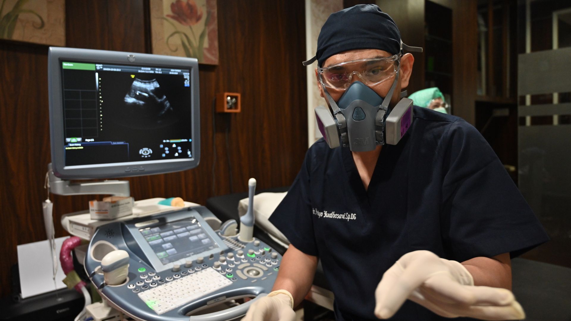 This picture taken on June 25, 2020 shows doctor Priyo Yudhosari speaking about the IUD contraceptive device works at a clinic in Jakarta.