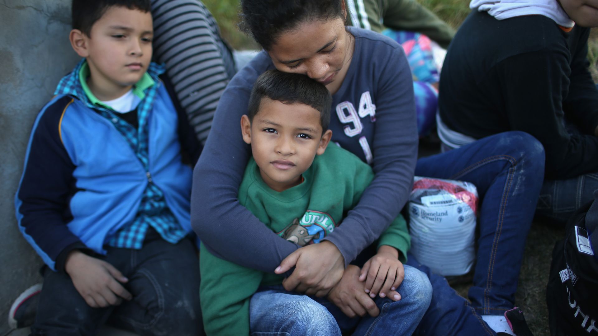 A Honduran mother holds her son, 7, after she turned her family in to U.S. Border Patrol agents on December 8, 2015 near Rio Grande City, Texas. 