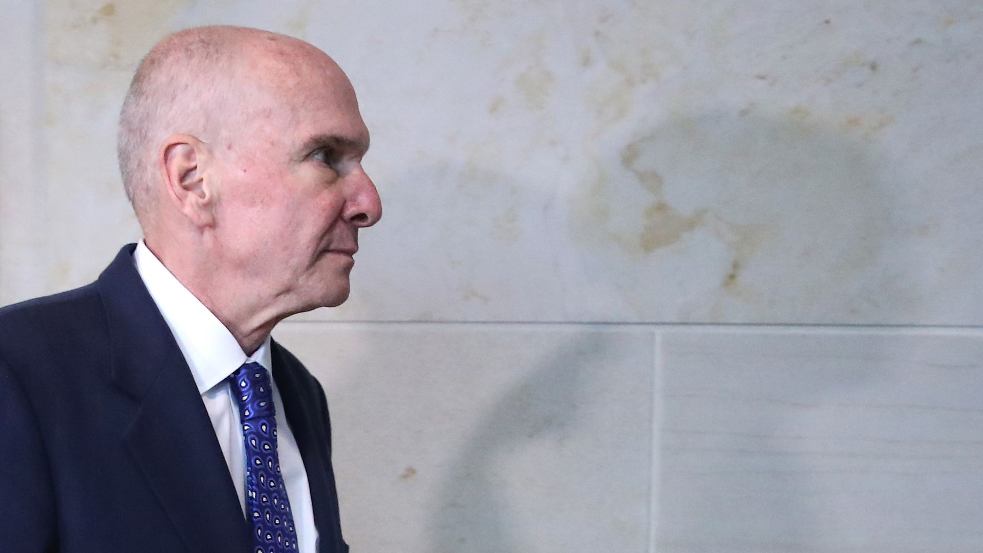 Michael McKinley walks in Congress with his shadow looming before him