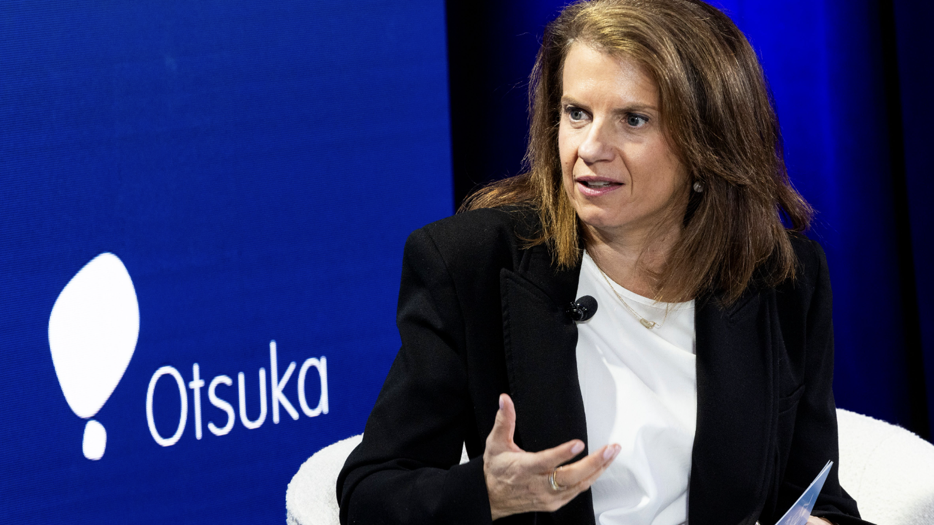 A woman talking to someone to the side. 