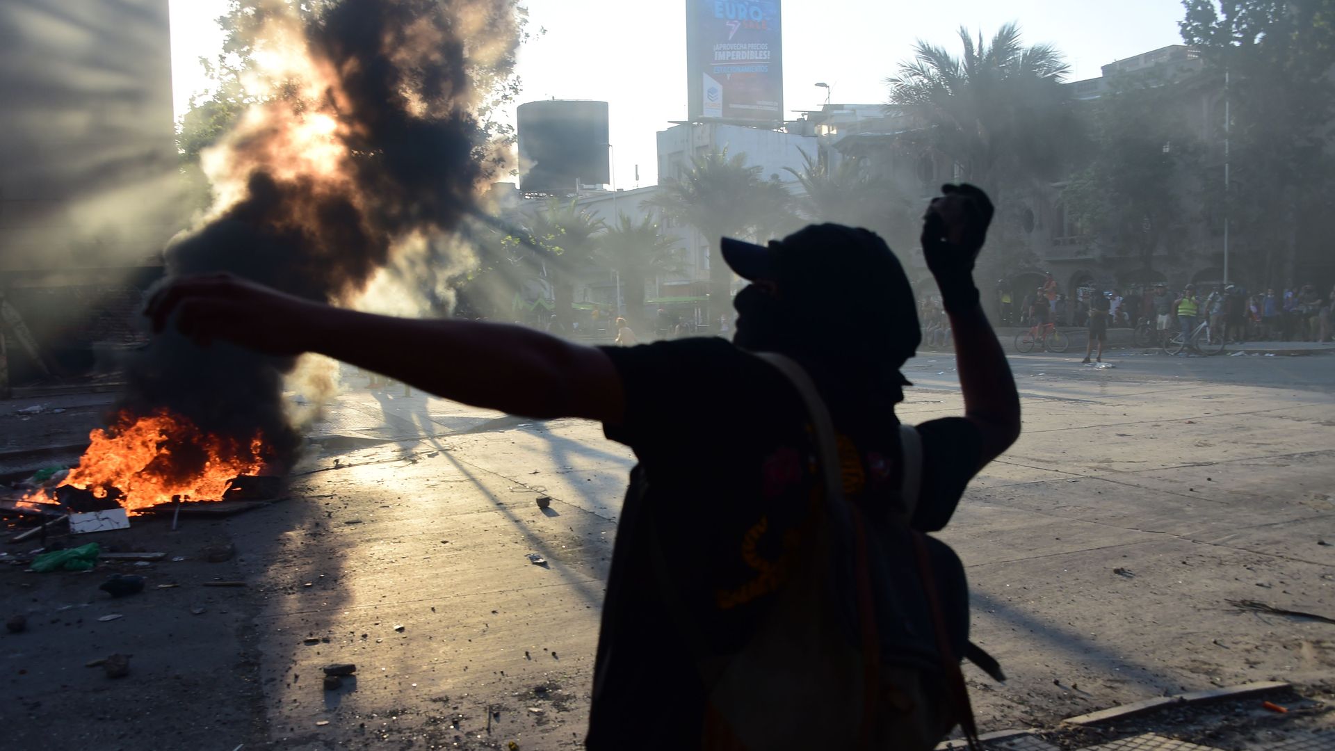 A demonstrator throws a stone at riot police on Nov. 13, 2019.