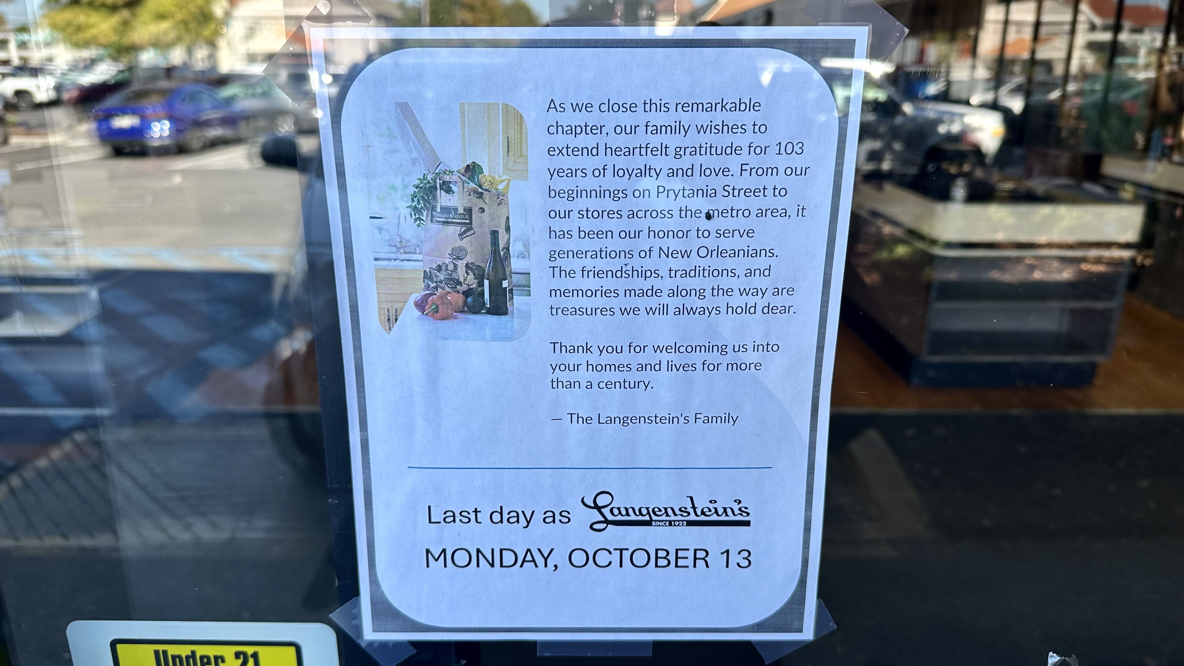 A printed notice on a window announces the closing of Langenstein's, thanking customers for 103 years of loyalty and stating the last day as Monday, October 13, from The Langenstein's Family.