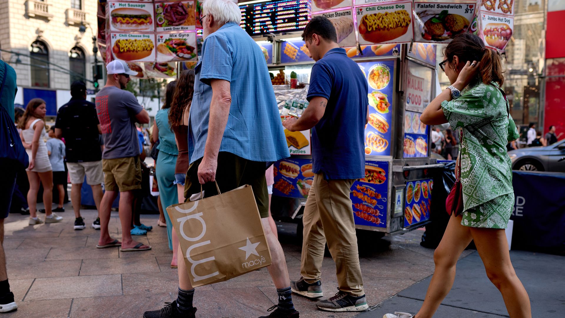 A pedestrian carries a Macy's Inc. branded shopping bag in New York, US, on Tuesday, July 29, 2025.