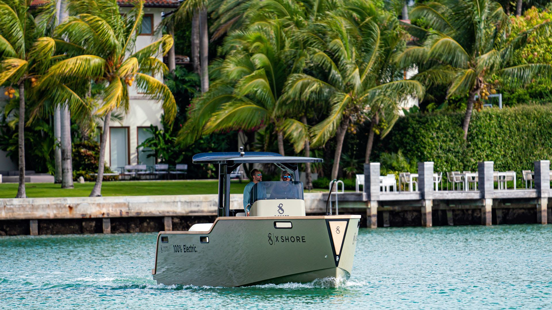 An electric boat being driven in the water. 