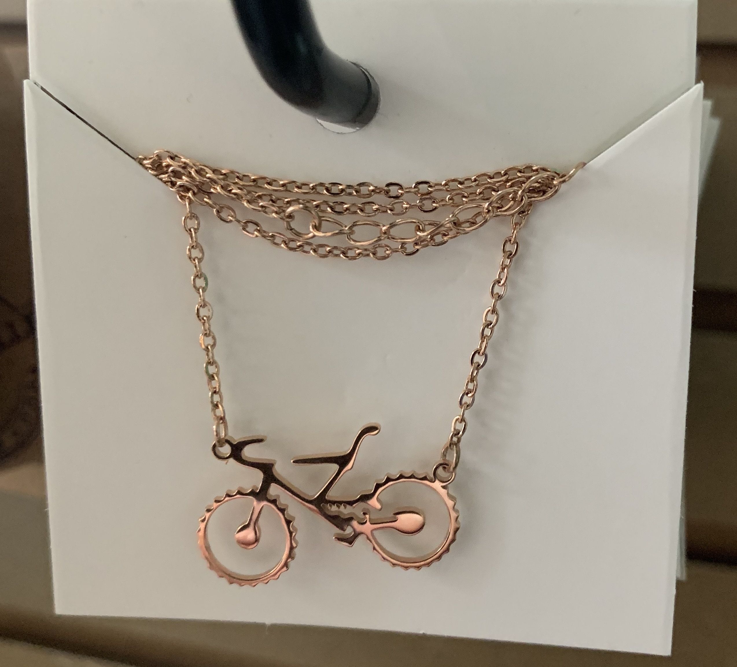 A bike on a necklace.