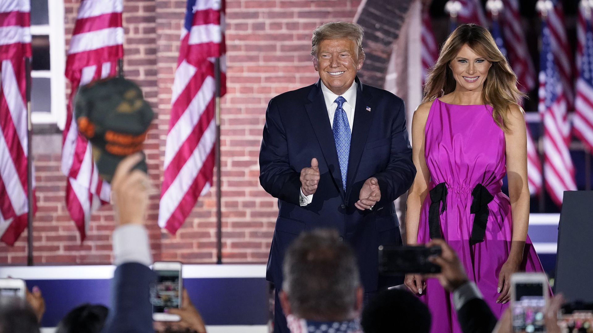 President Donald Trump and first lady Melania Trump on stage.