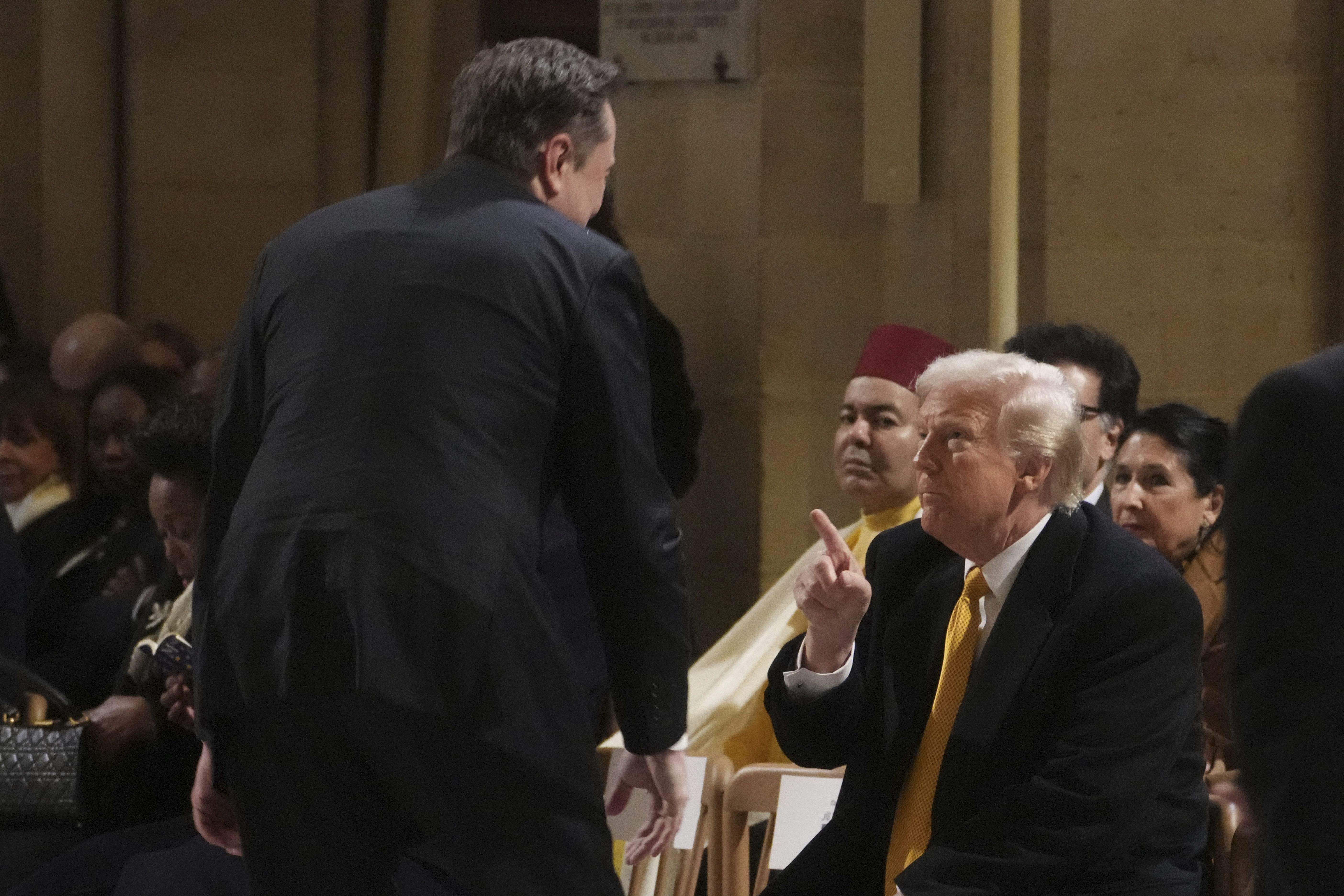 President-elect Donald Trump points to Elon Musk at the reopening of Notre Dame in Paris on Saturday.