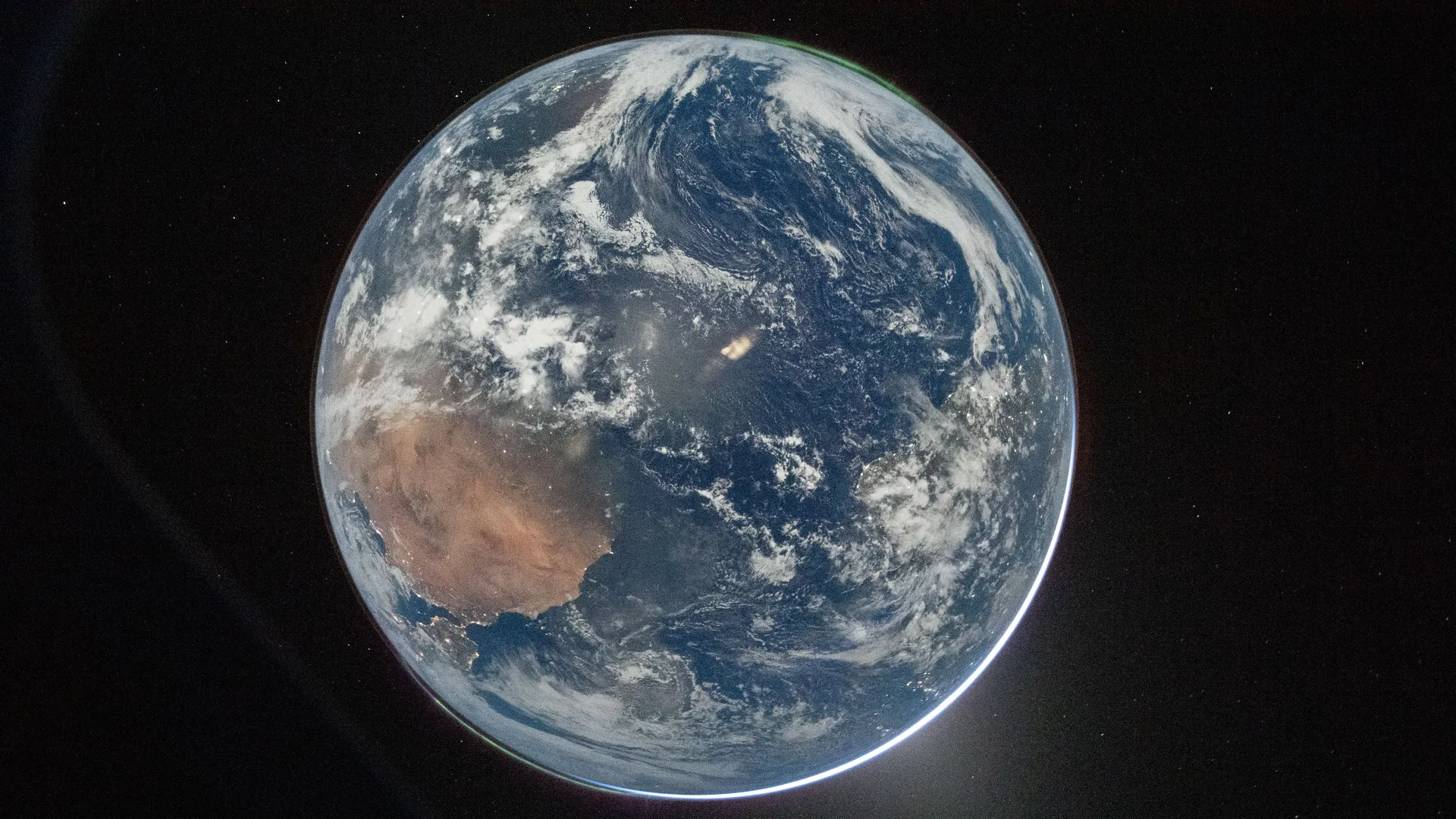 NASA astronaut and Artemis II Commander Reid Wiseman took this picture of Earth from the Orion spacecraft’s window after completing the translunar injection burn. There are two auroras (top right and bottom left) and zodiacal light (bottom right) is visible as the Earth eclipses the Sun.