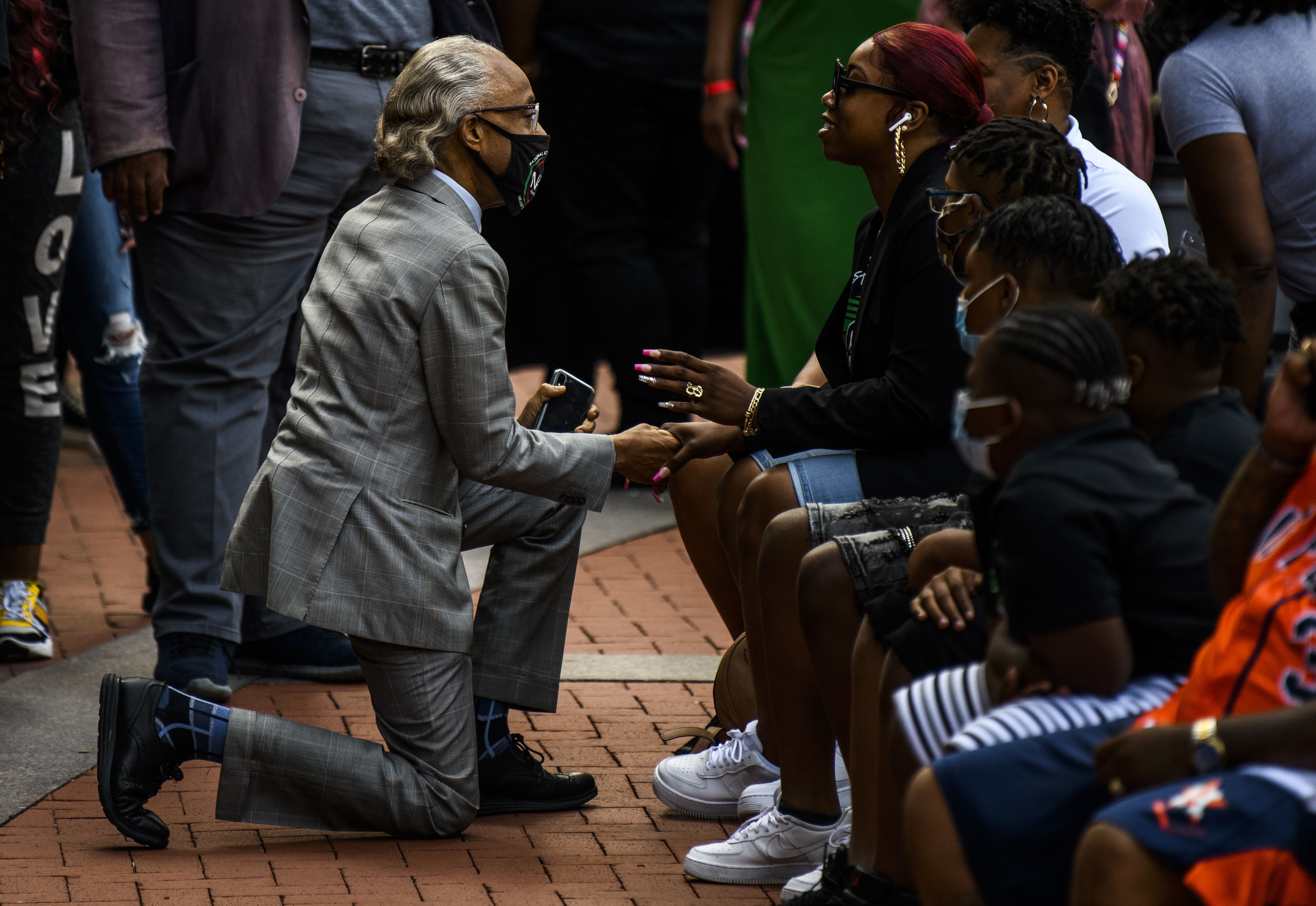 Rev. Al Sharpton (L) greets Bridgette Floyd, sister of George Floyd, as people attend a rally outside the Hennepin County Government Center on May 23, 2021 in Minneapolis, Minnesota. 