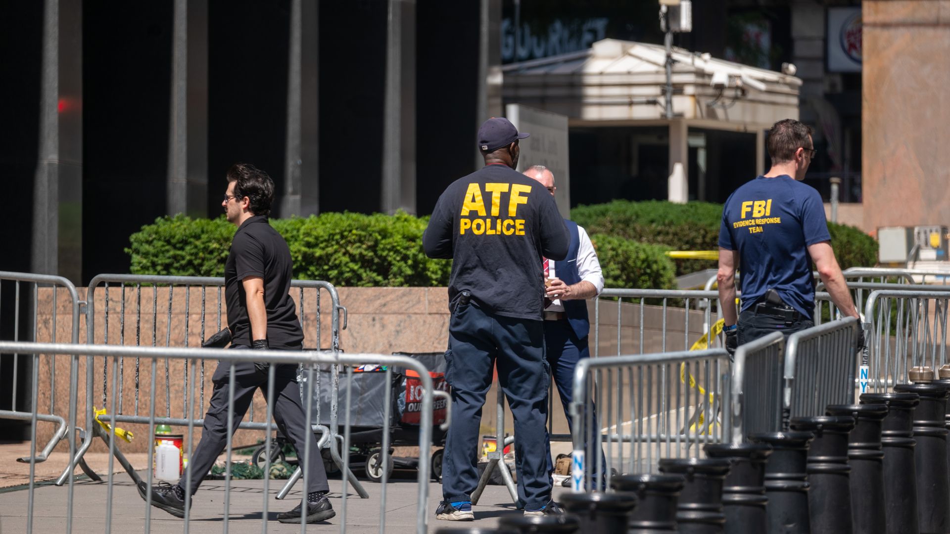 Investigators from various agencies, including the FBI, gather outside of 26 Federal Plaza in Lower Manhattan after an incendiary device went off outside the building early on July 20, 2026 in New York City.
