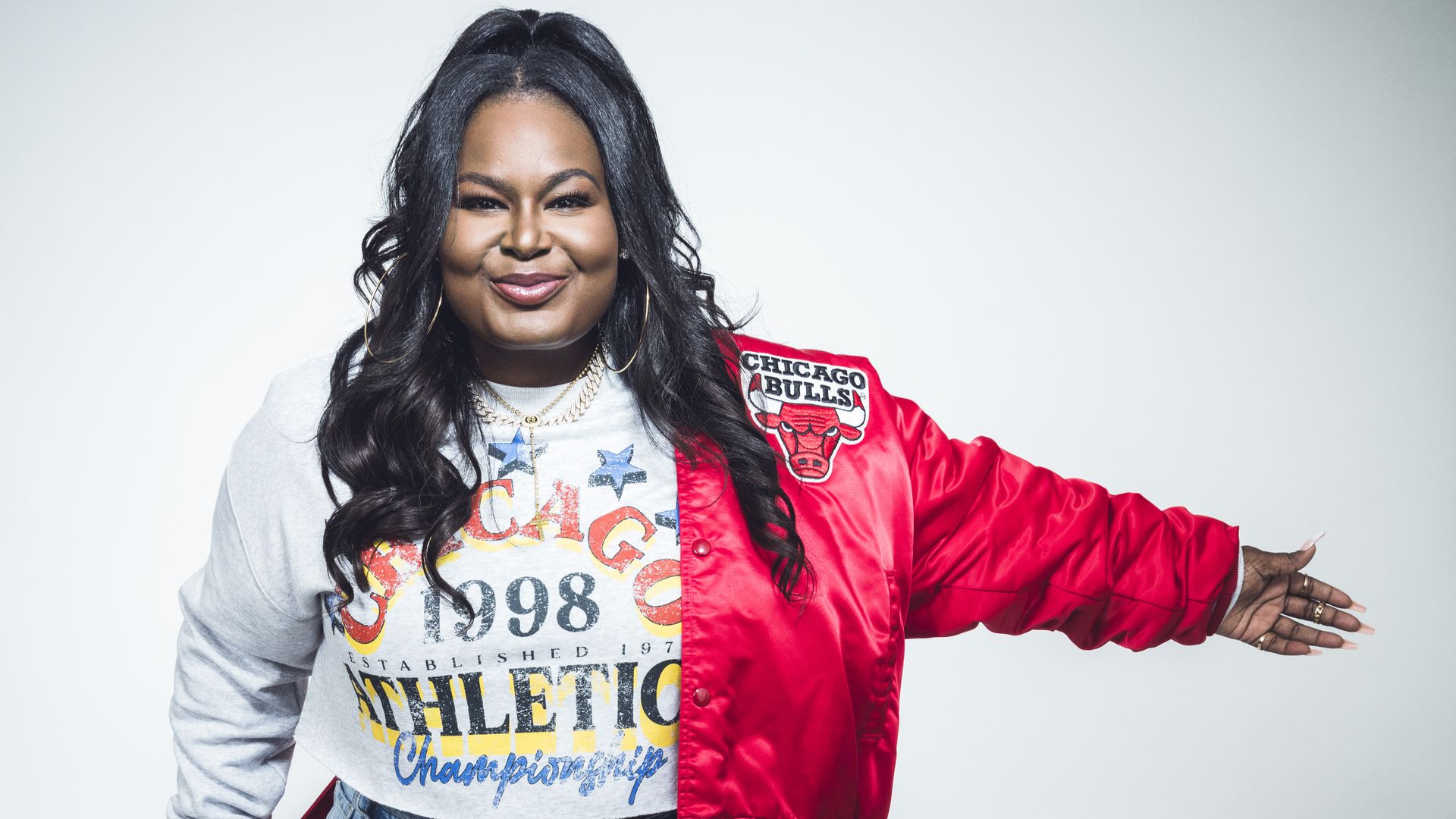 Photo of a woman posing with a jacket on 