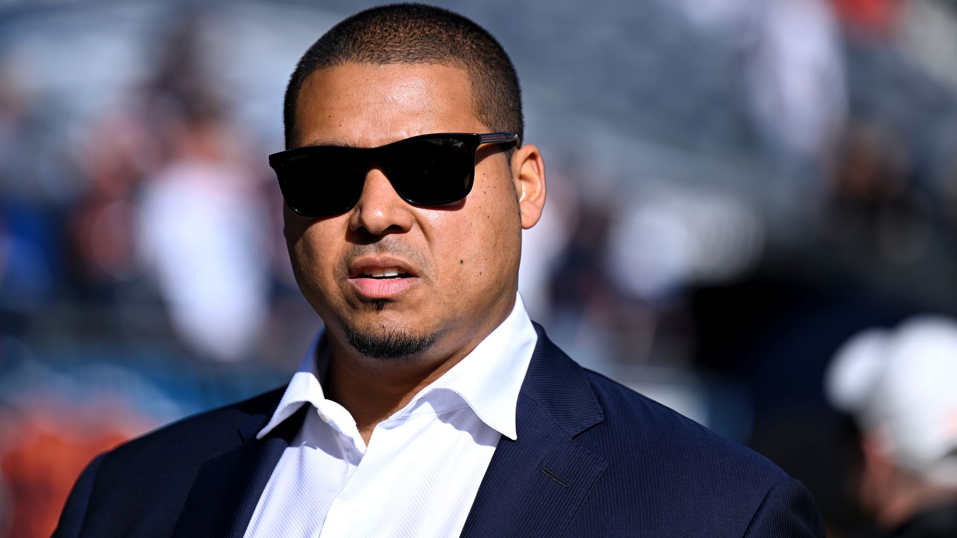 Photo of a man on a field with sunglasses on 