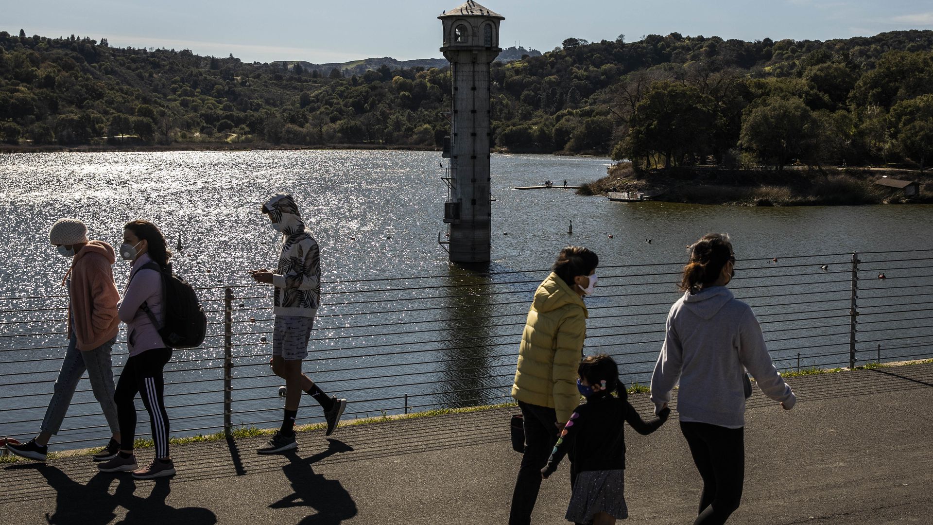 People waling along a reservoir near Orinda, California, in February.