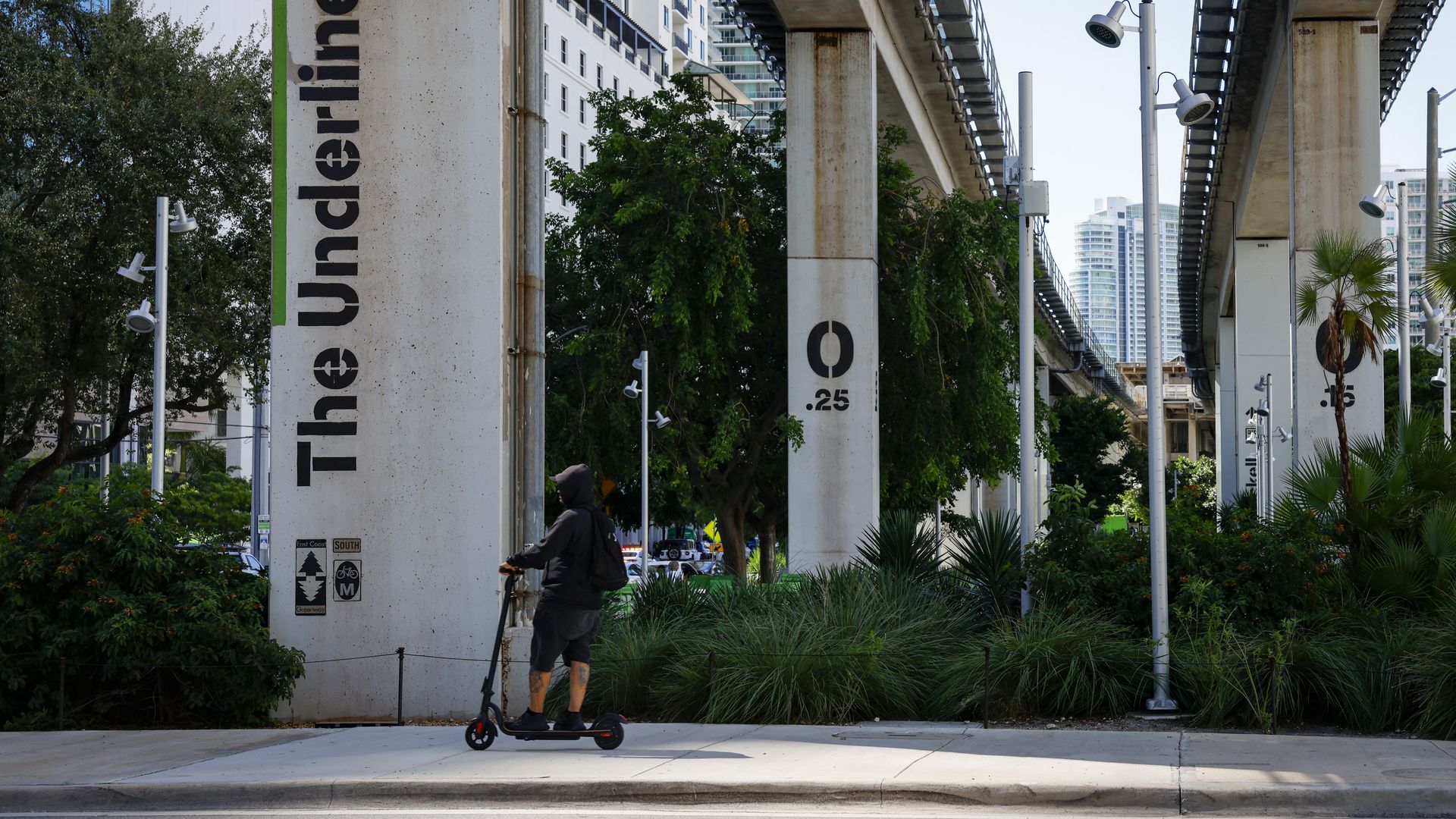 A person on a scooter riding through the Underline.