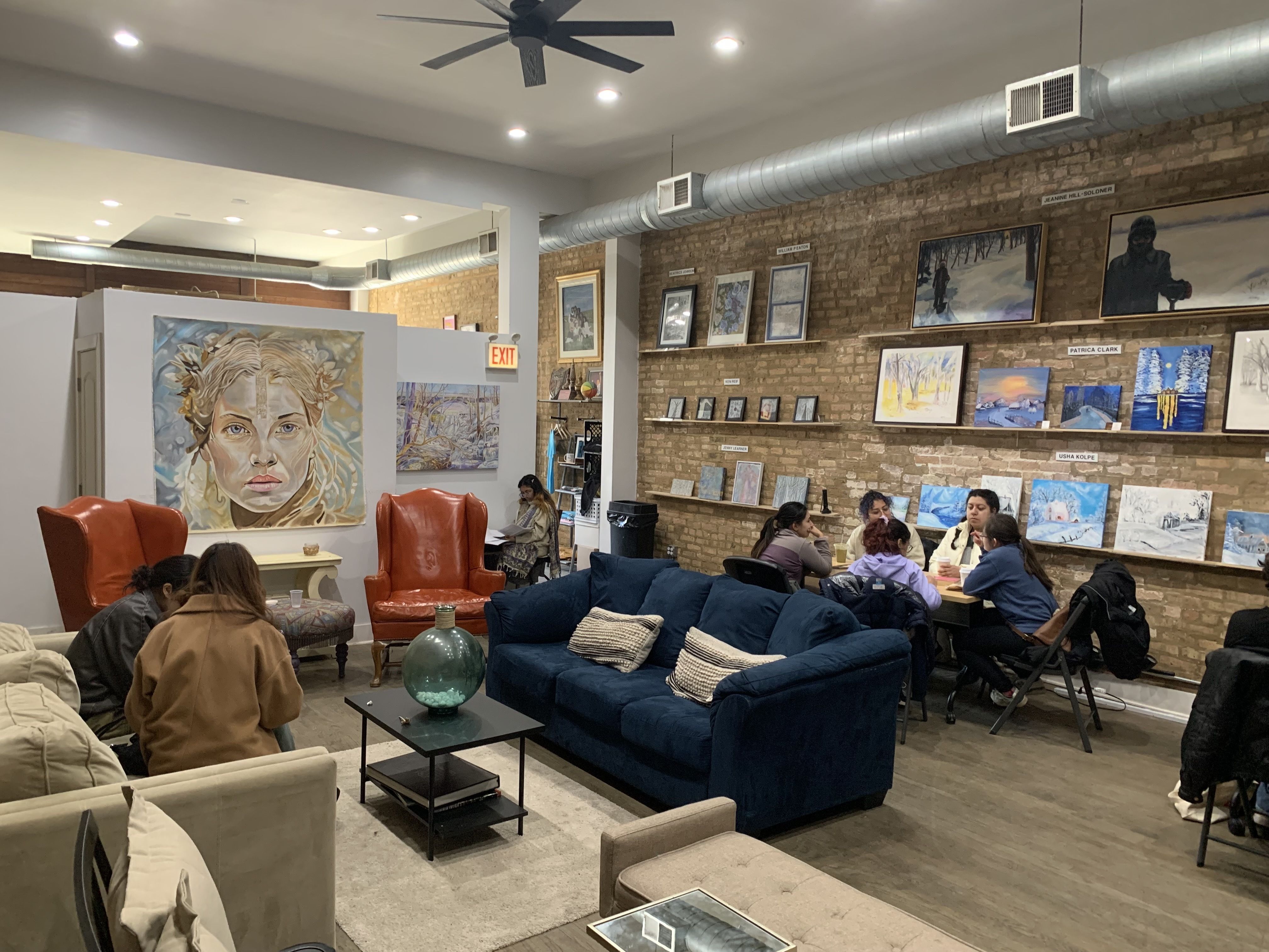 Photo of a coffee shop with couches and art on the walls 