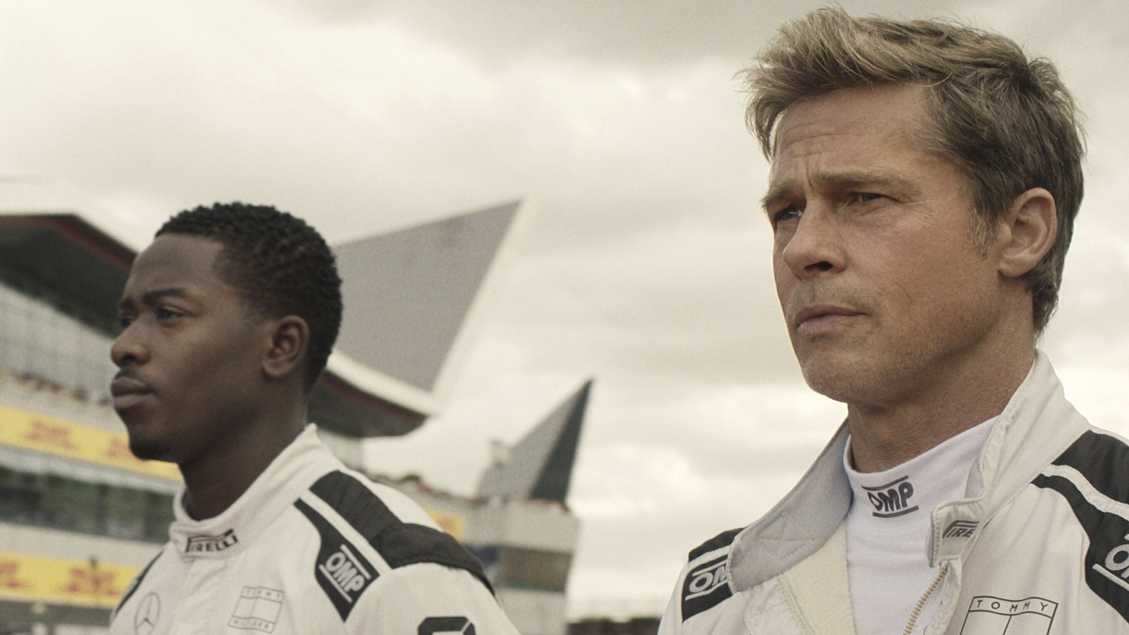This image released by Apple TV+ shows Damson Idris as Joshua Pearce, left, and Brad Pitt as Sonny Hayes in a scene from "F1 The Movie." (Apple TV+ via AP)