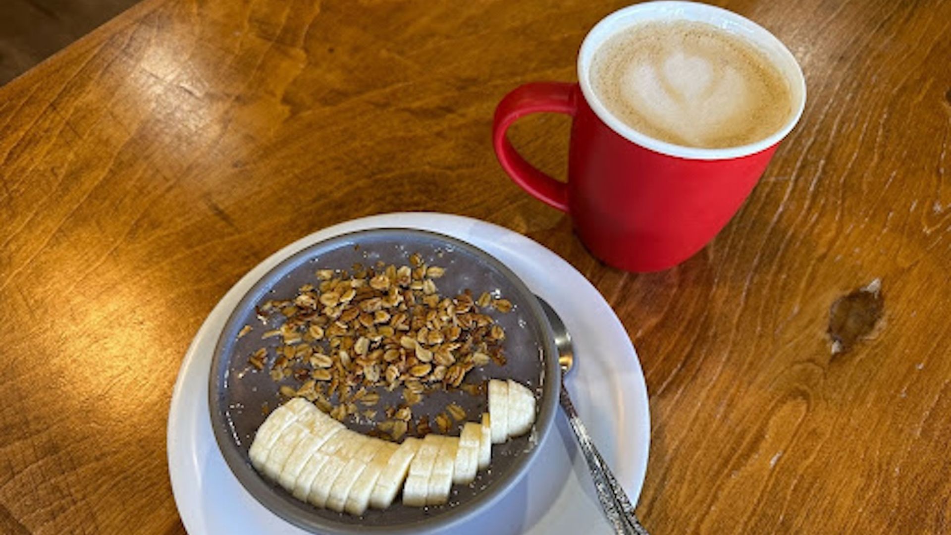 An almond latte and the Squirrel Special acai bowl from Treehouse Cafe. Photo: Glenn Wallace/Axios