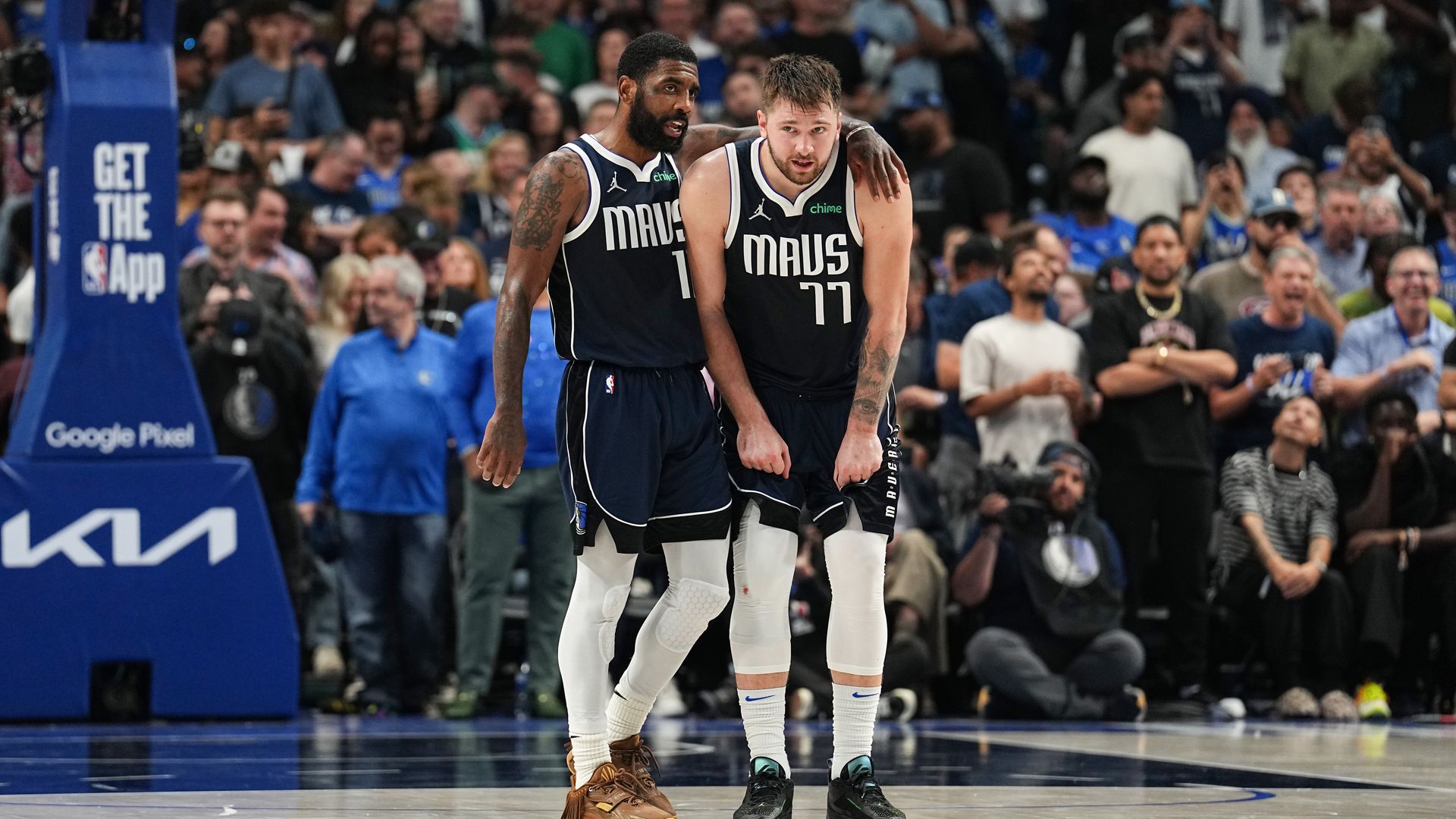 Dallas Mavericks Kyrie Irving wraps his arm around Luka Doncic