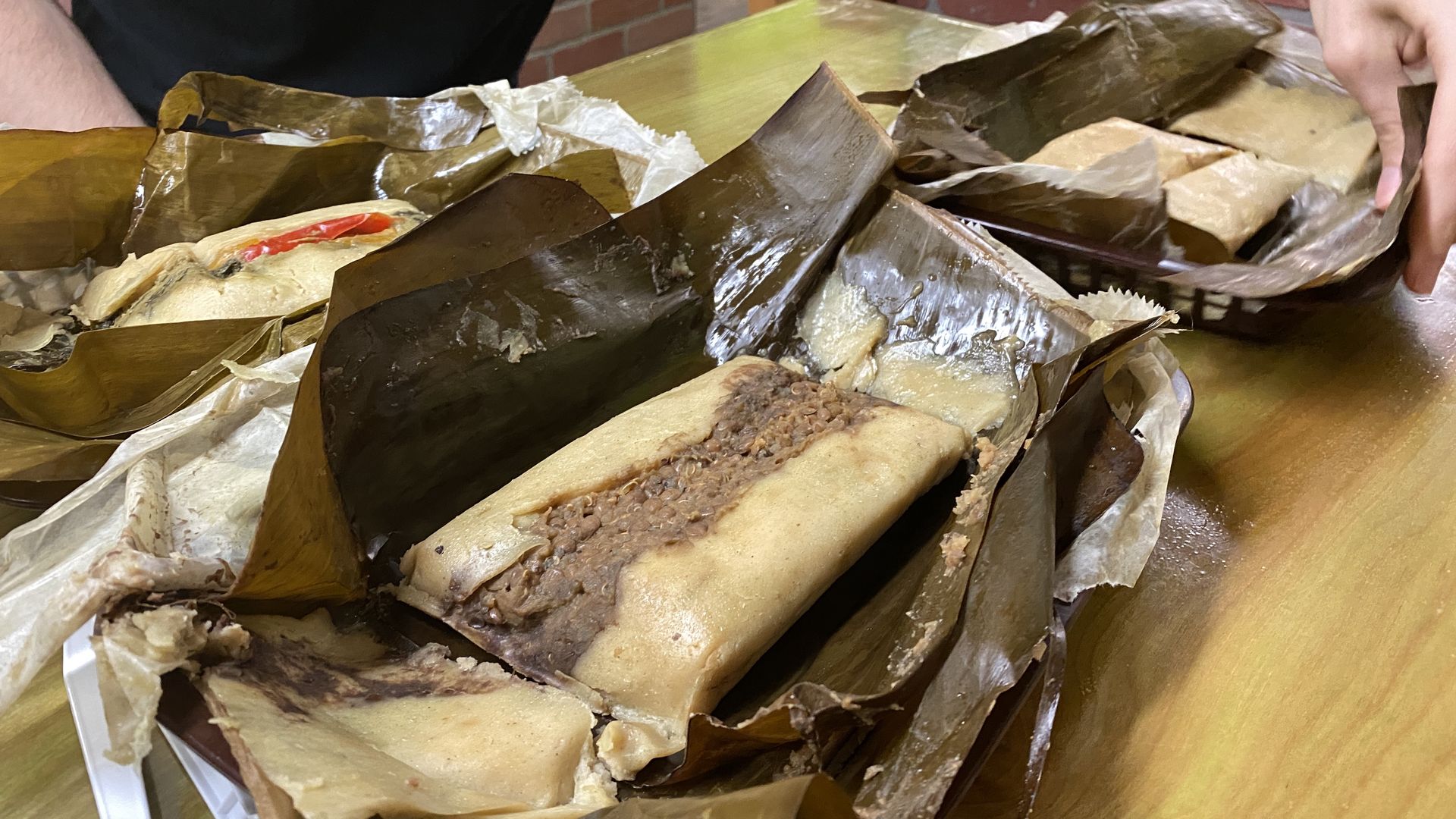 A quinoa and lentil tamale in a corn husk.
