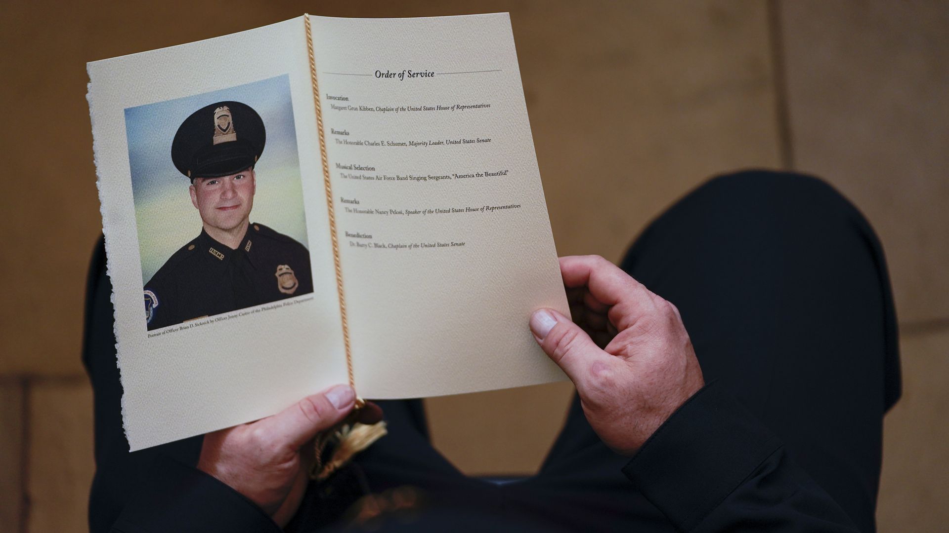 A U.S. Capitol Police Officer holds a program for the ceremony memorializing U.S. Capitol Police Officer Brian D. Sicknick, 42, as he lies in honor in the Rotunda of the Capitol on February 3, 2021.
