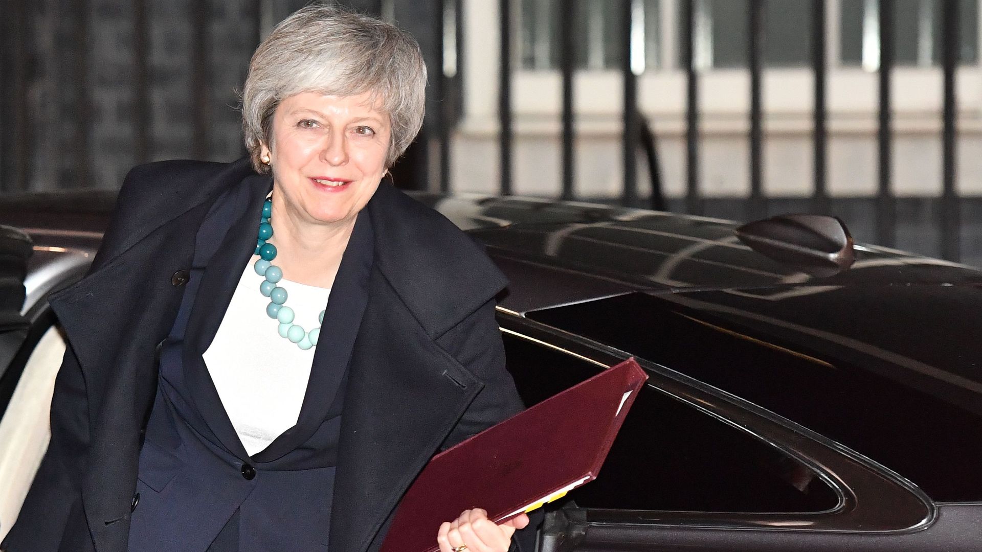 Theresa May getting out of a car