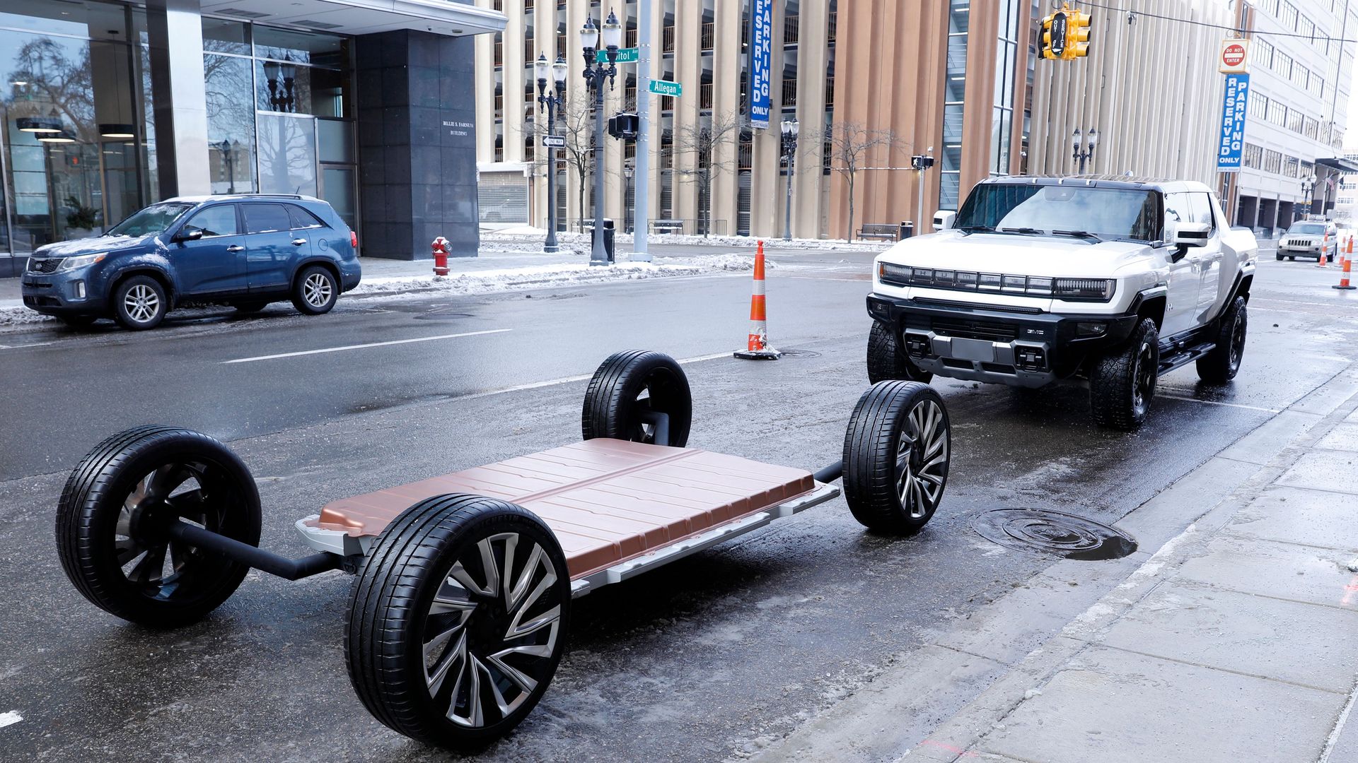A battery pack for an EV is positioned on the road in front of an EV