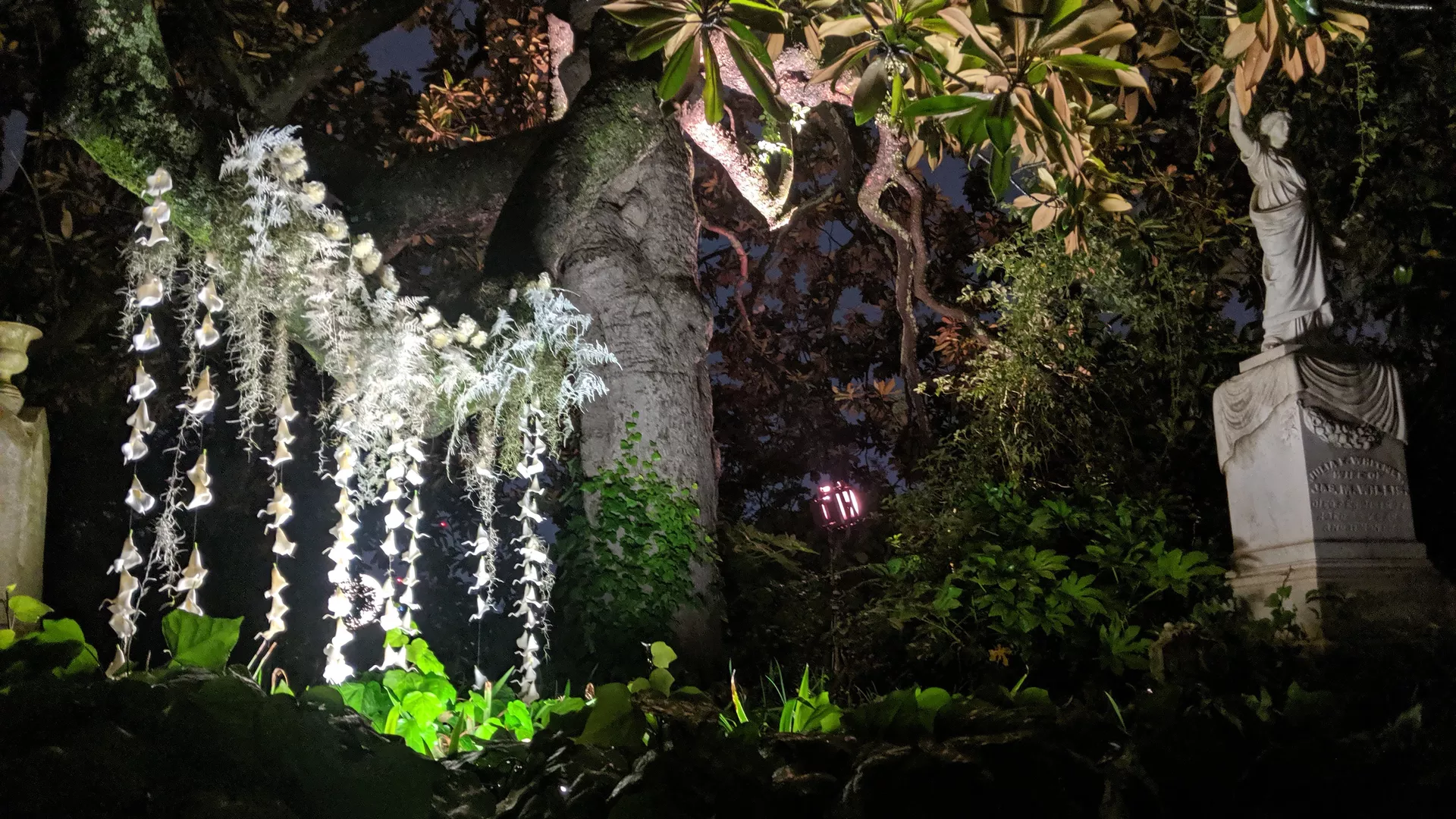 A lush green cemetery at night