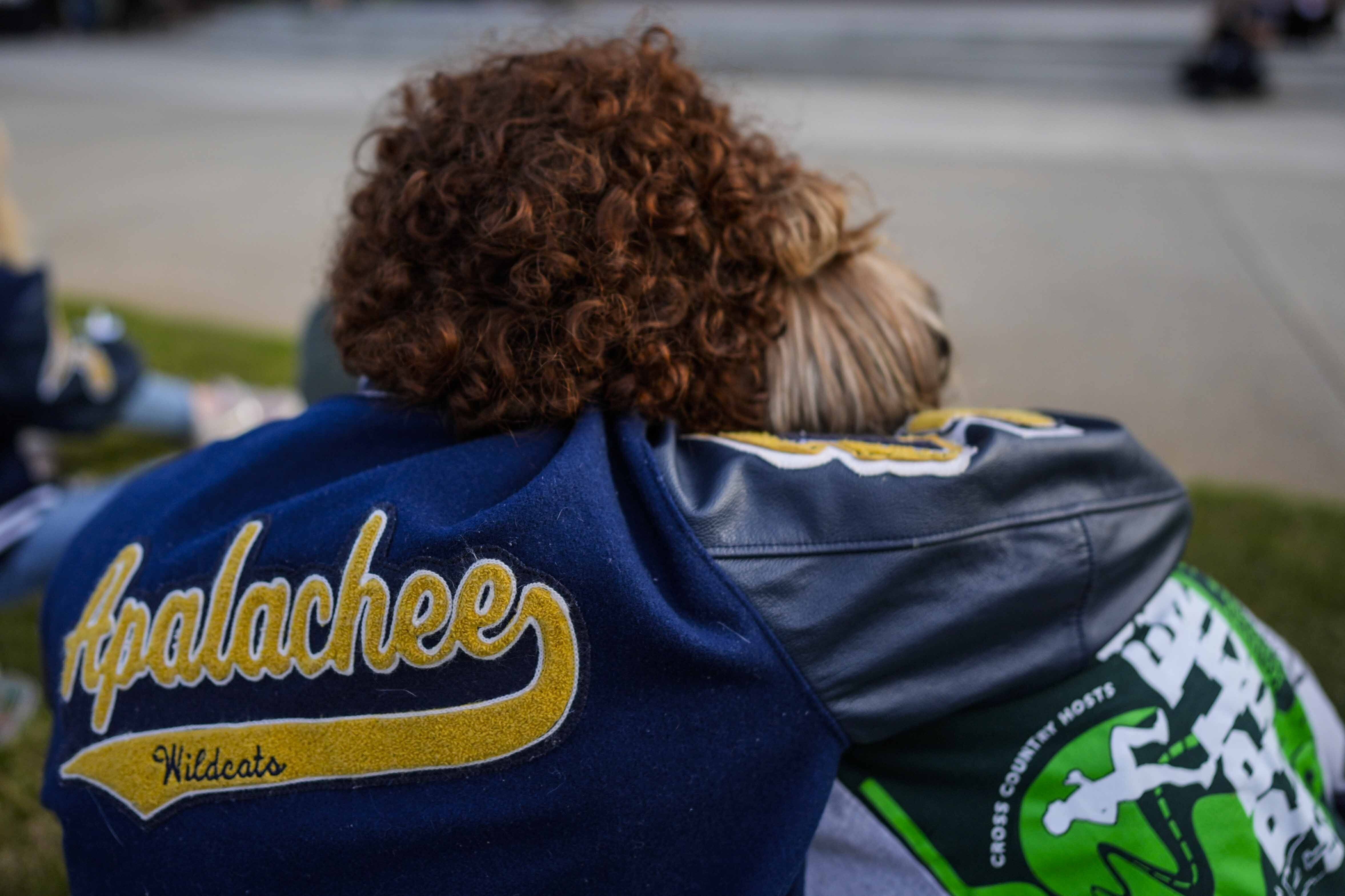 Mourners listen to a speaker during a candlelight vigil for the slain students and teachers at Apalachee High School in Georgia yesterday.