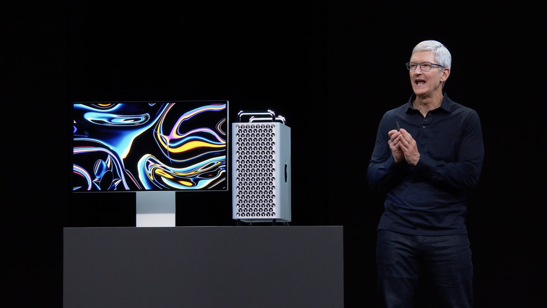 Apple CEO Tim Cook standing next to new model Mac Pro 
