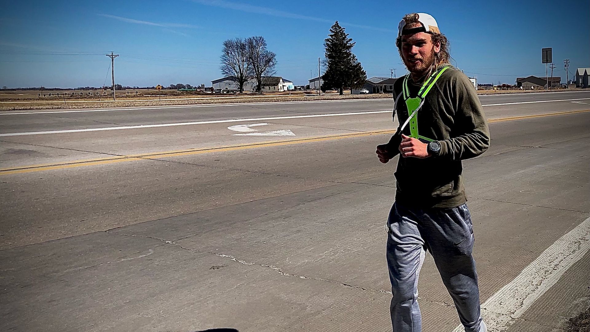 A photo of Paul Noble running outside on a sunny day.