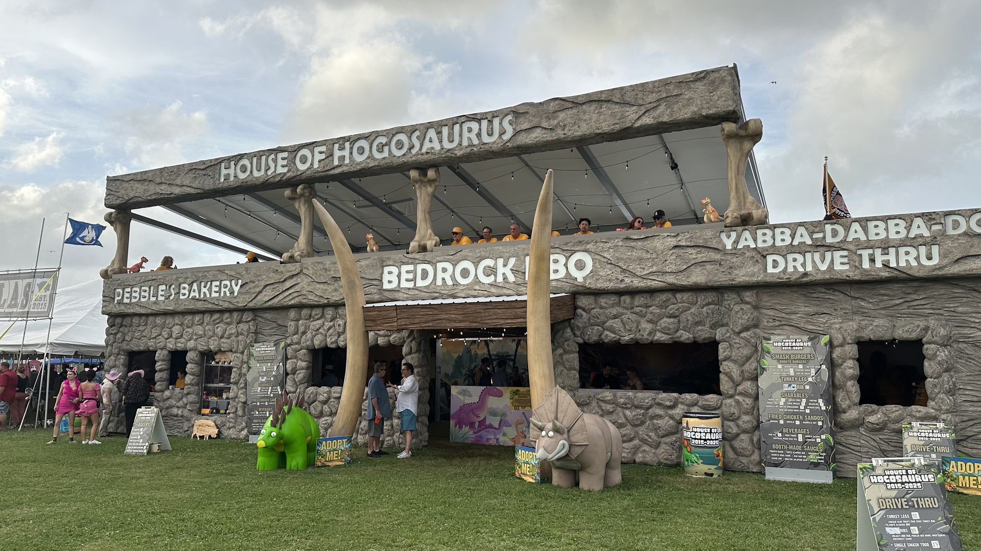 Photo shows a tent that say "House of Hogosoaurus."