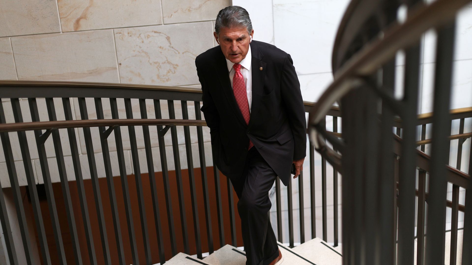 Sen. Joe Manchin is seen walking up a staircase in the Capitol Visitor Center.