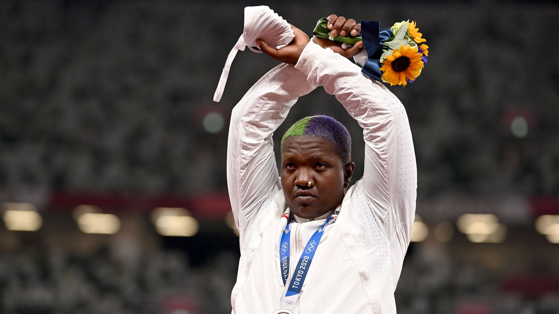 Second-placed USA's Raven Saunders gestures on the podium with her silver medal after competing the women's shot put event during the Tokyo 2020 Olympic Games