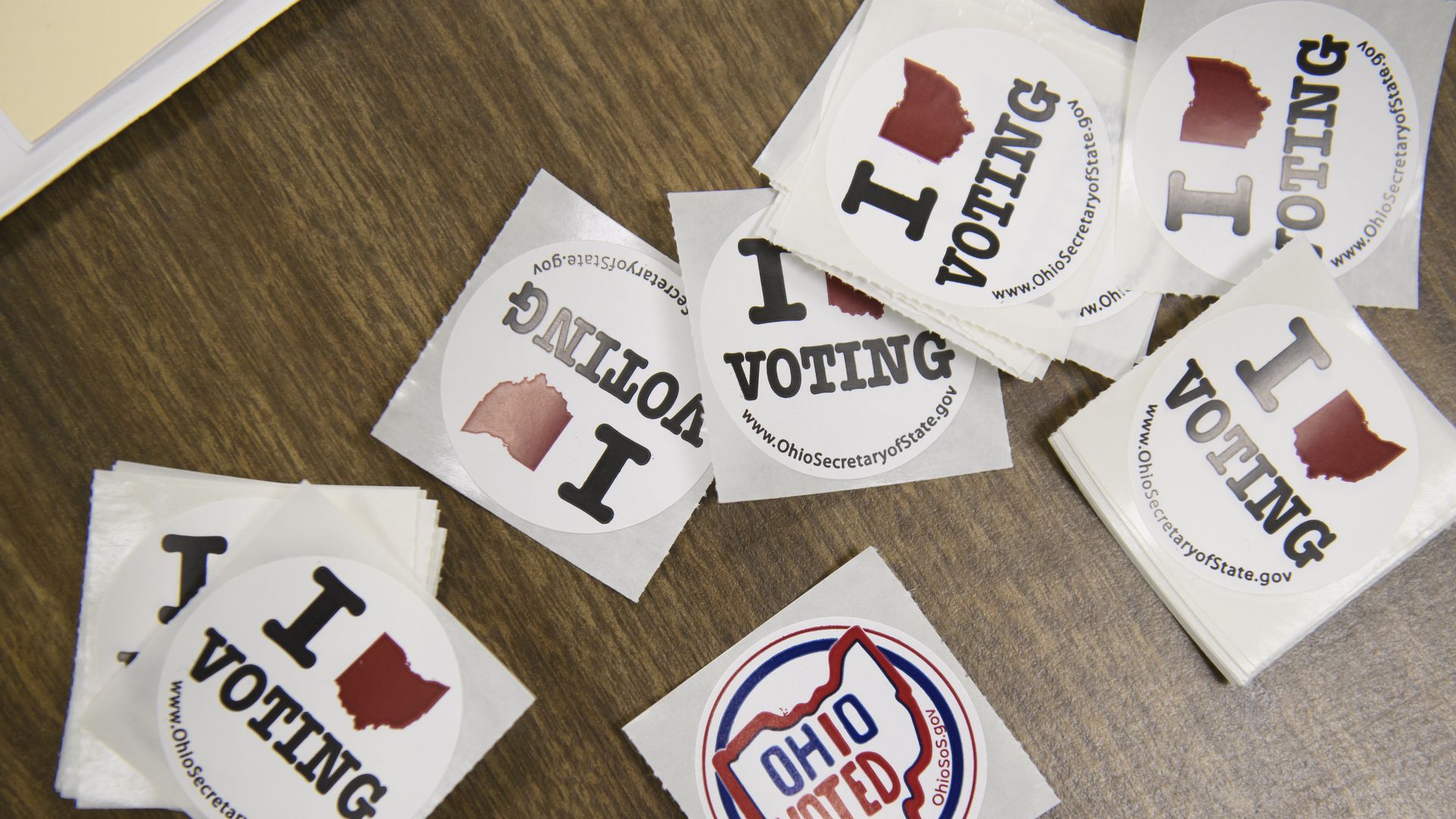 A table full of Ohio voting stickers. 