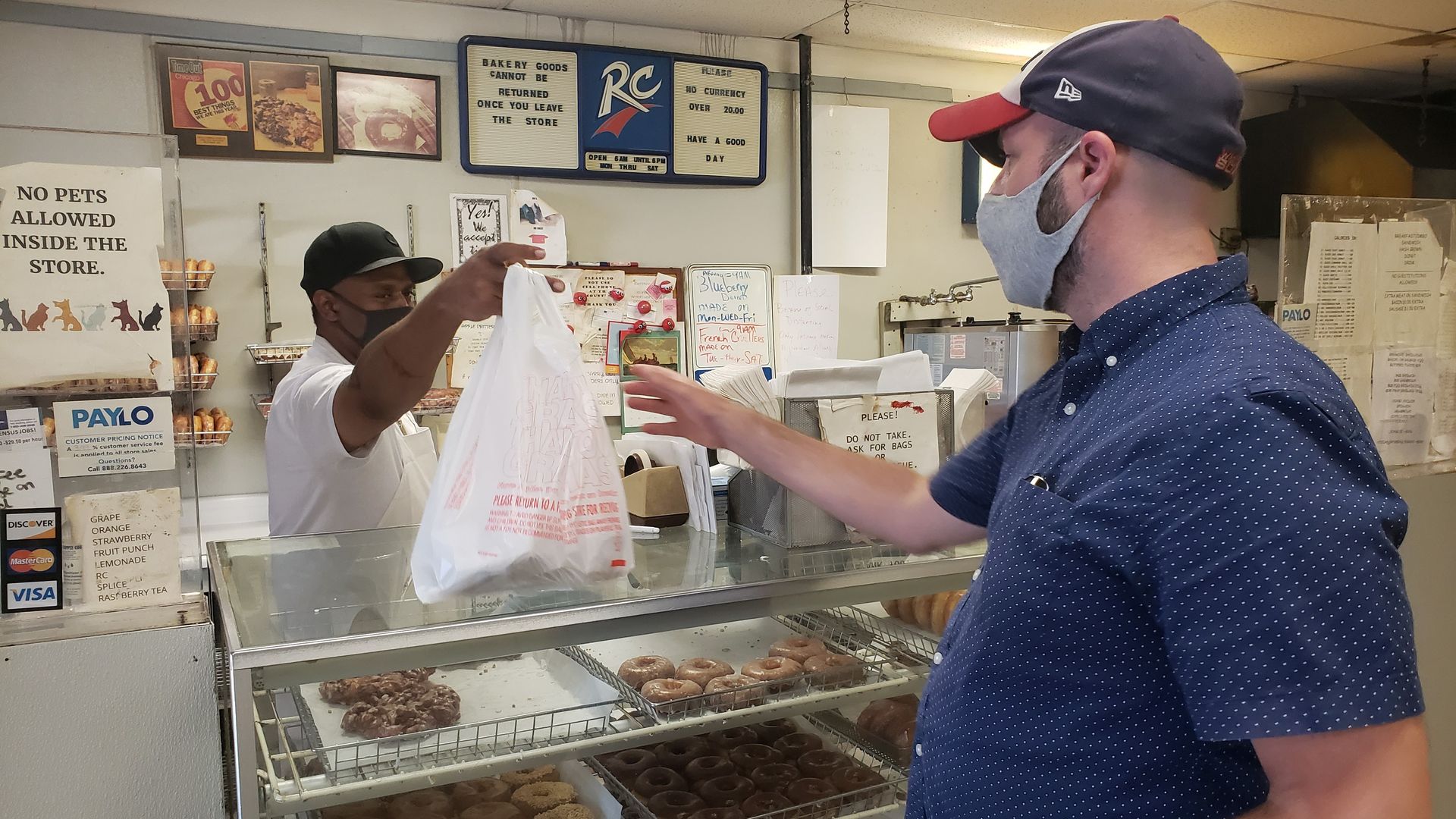 Justin gets an order of food in a plastic bag. 
