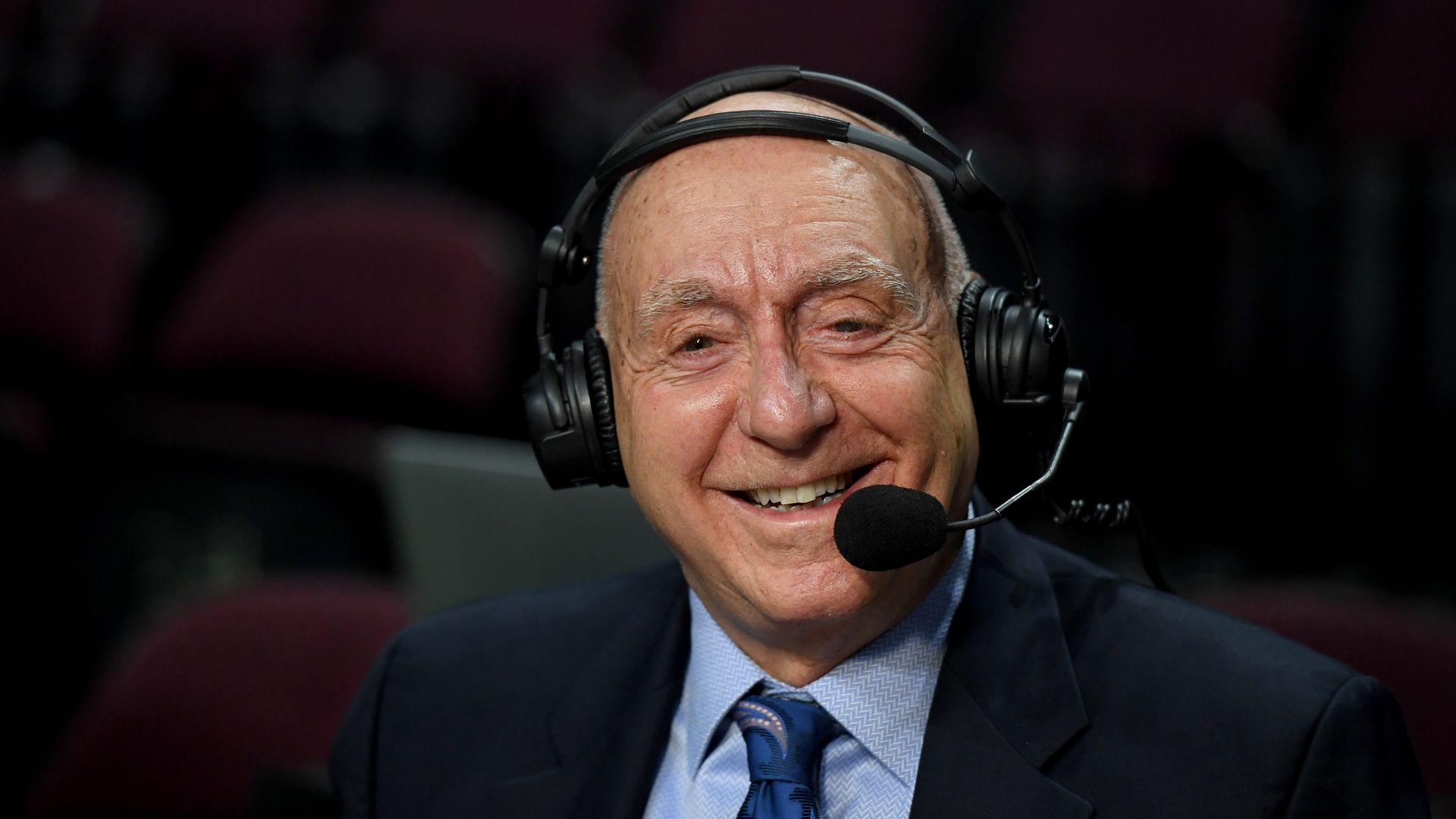 Sportscaster Dick Vitale broadcasts before a basketball game.
